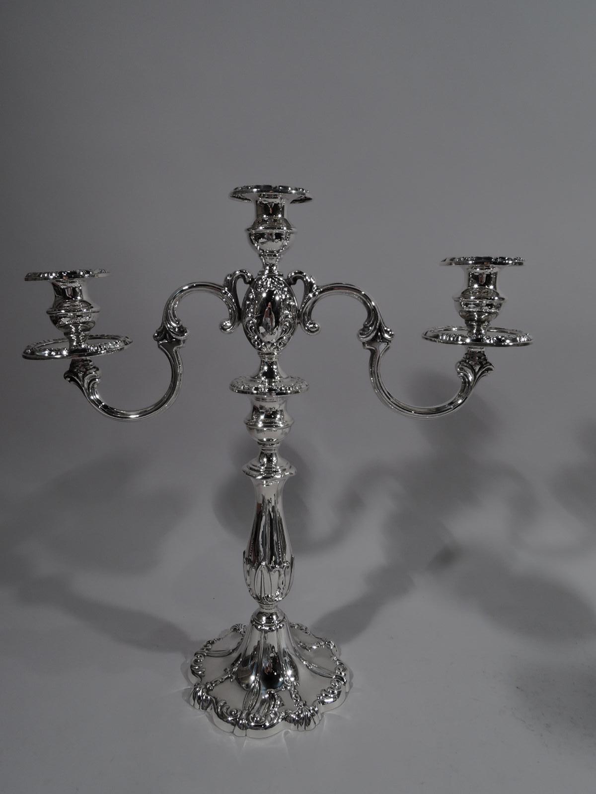 Pair of 3-light Rochambeau sterling silver candelabra. Made by Mueck-Carey in New York. Each: Baluster shaft on domed and scrolled foot. Central socket on oval support mounted with scrolled arms, each terminating in single socket. Each socket