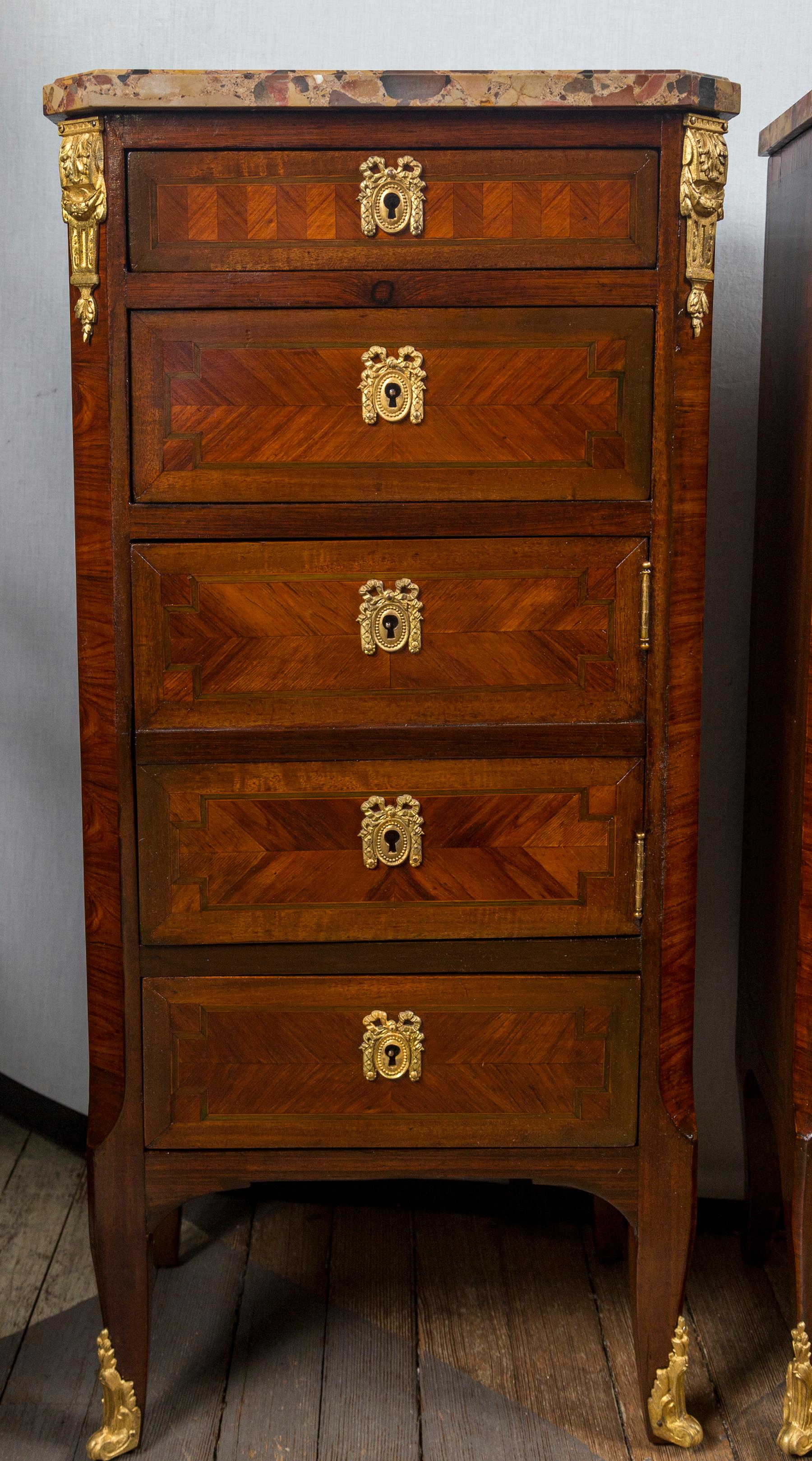 In the transitional French style with parquetry veneers, gilt bronze escutcheons, top corner mounts and sabots. Three drawers that open and a cabinet with faux draw fronts, on one. (hinged right side), the other having 5 drawers
I can provide a key