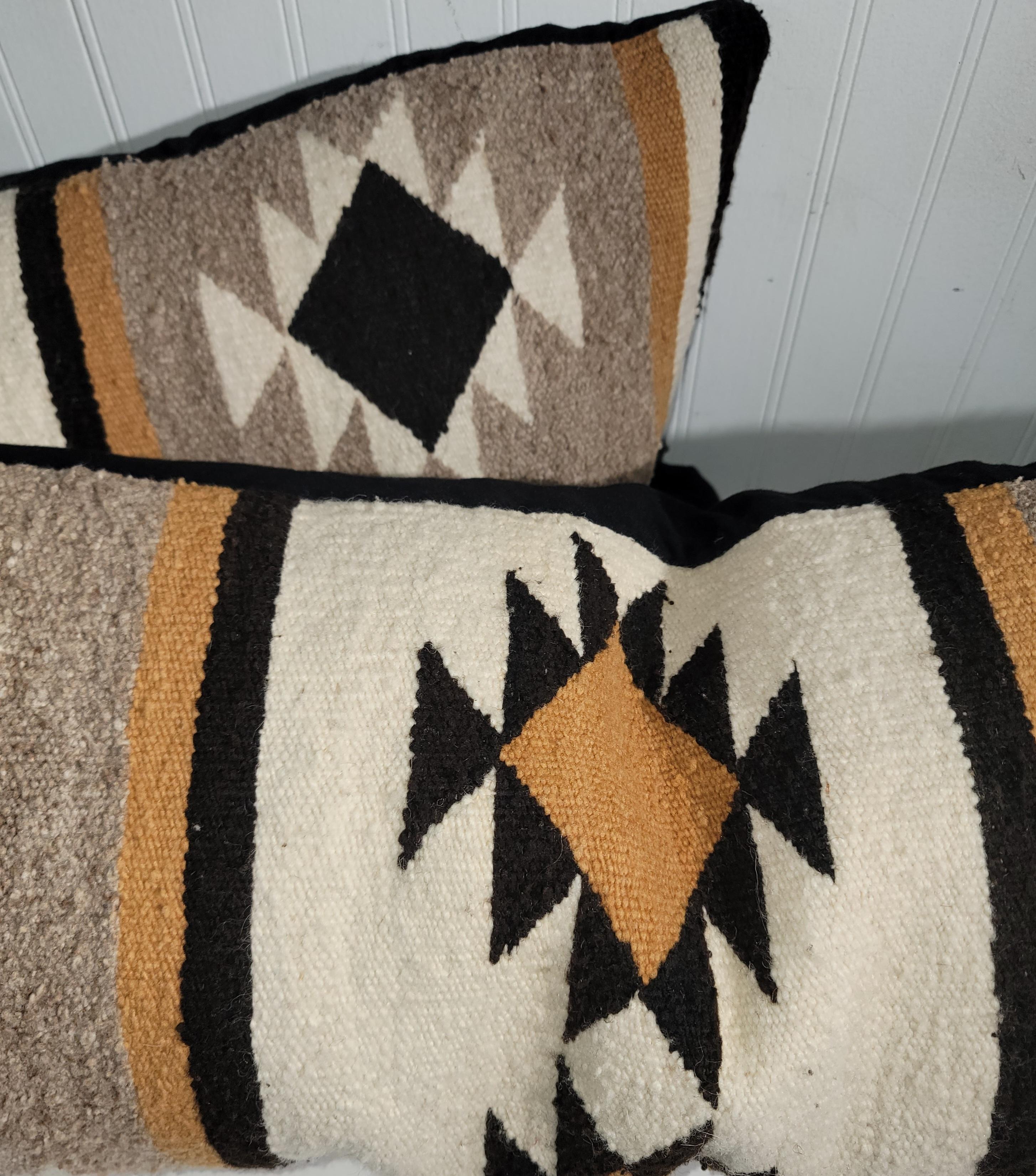 Pair or wool pillows made from vintage wool eye dazzlers, cotton linen backing and down and feather inserts. These pillows are a great treat when seen tangibly. These beautiful pillows are long and slender. Perfect as a long bolster/kidney pillow. 