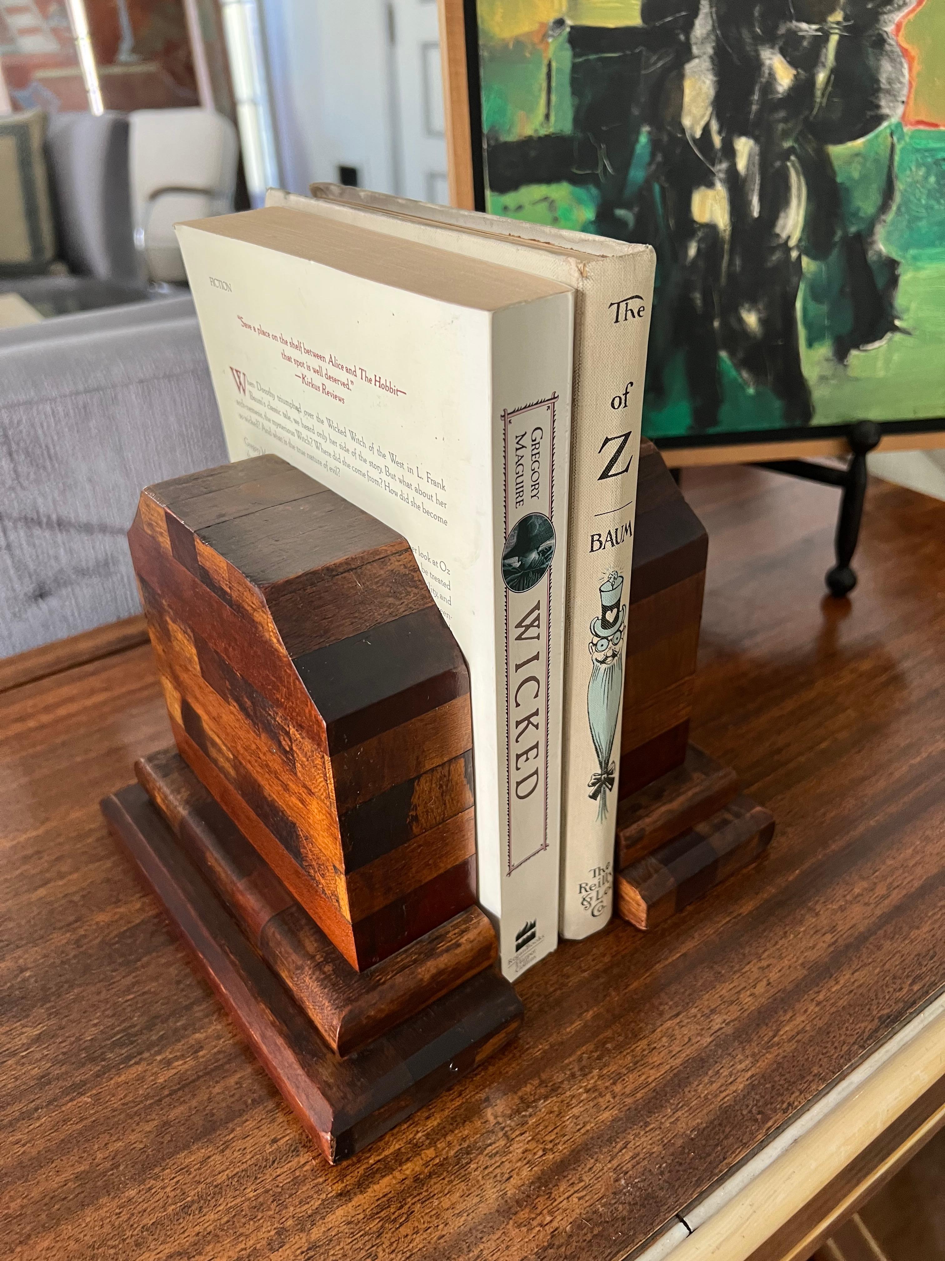 Pair of mixed-wood bookends. A compliment to any shelf or library. Reminiscent of Don Shoemaker - intricate attention to detail... A mosaic of rich wood colors, these bookends pair well with a variety of styles. These bookends are in great condition