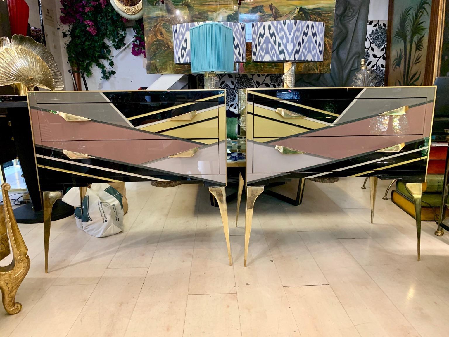 Pair of multicolored opaline glass (black, yellow, grey, powder pink and dove gray color) chest of drawers Geometric design, brass edges, handles and legs.
The top and one side are in black opaline glass, one side has the same geometric and