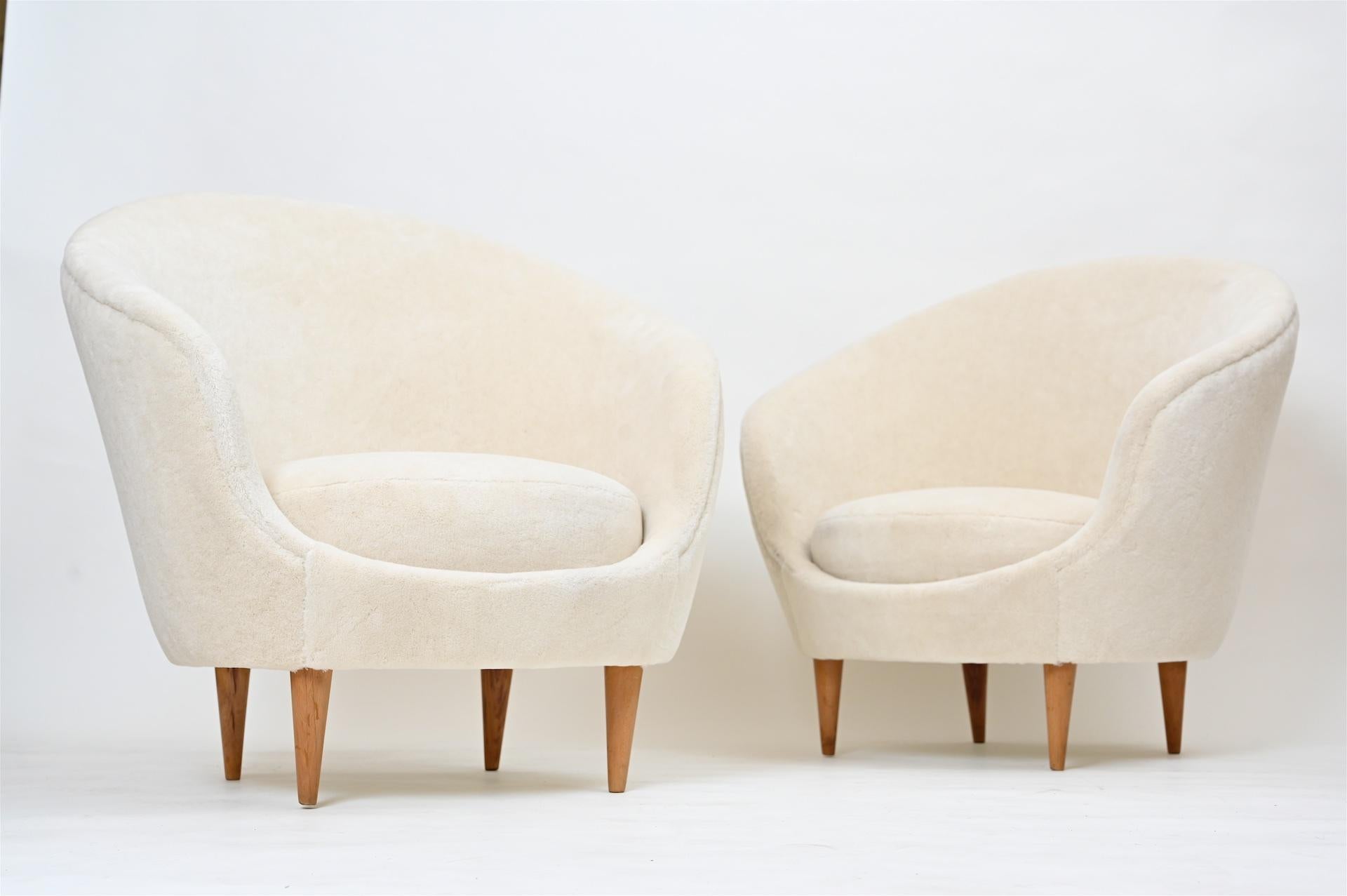 A pair of Frederico Munari armchairs re-upholstered in off white Alpaca velvet.

 