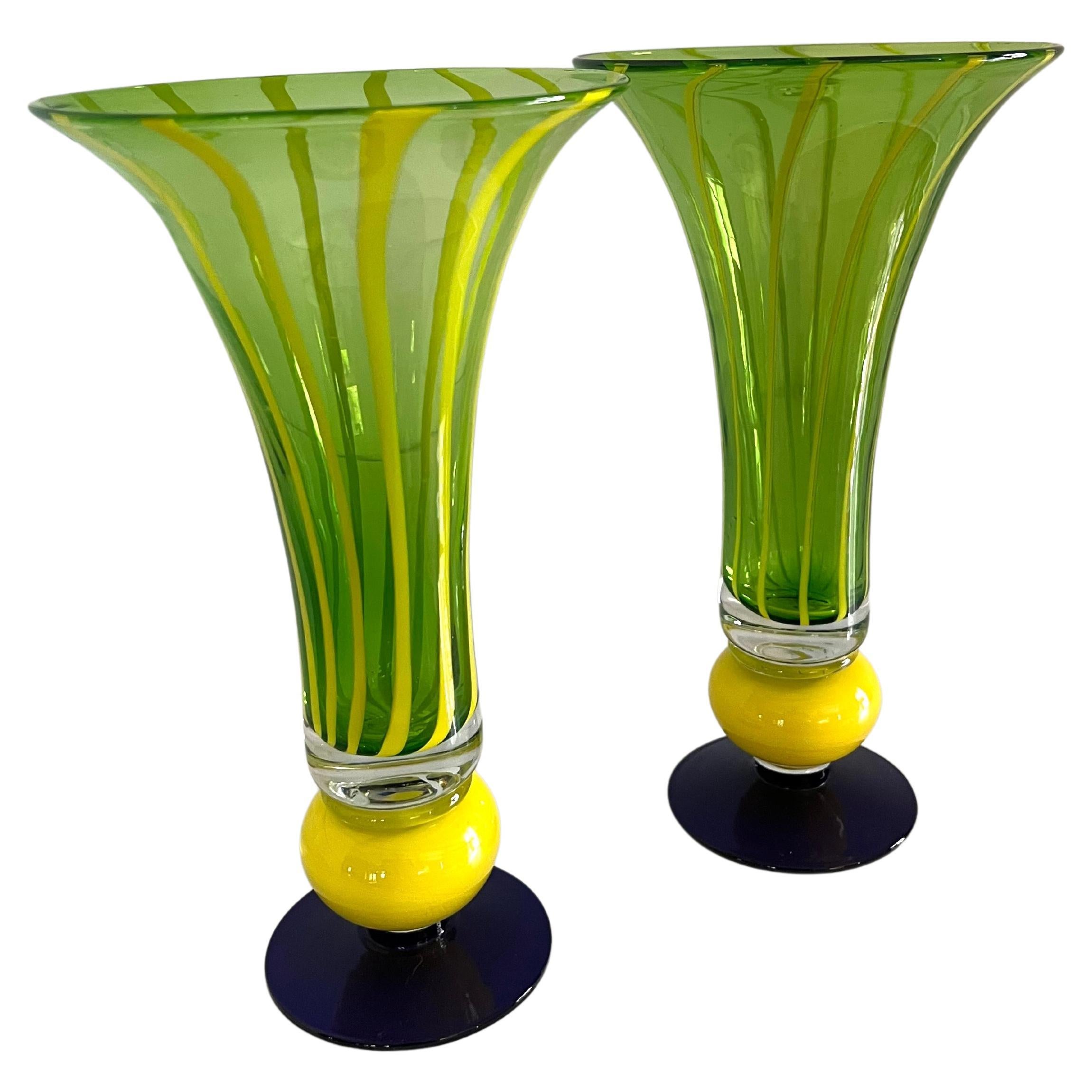 Pair of trumpet glass vases with blue base, yellow ball detail, and green and yellow striped body. A complement to living and dining rooms, or perhaps to bring additional color to the garden.