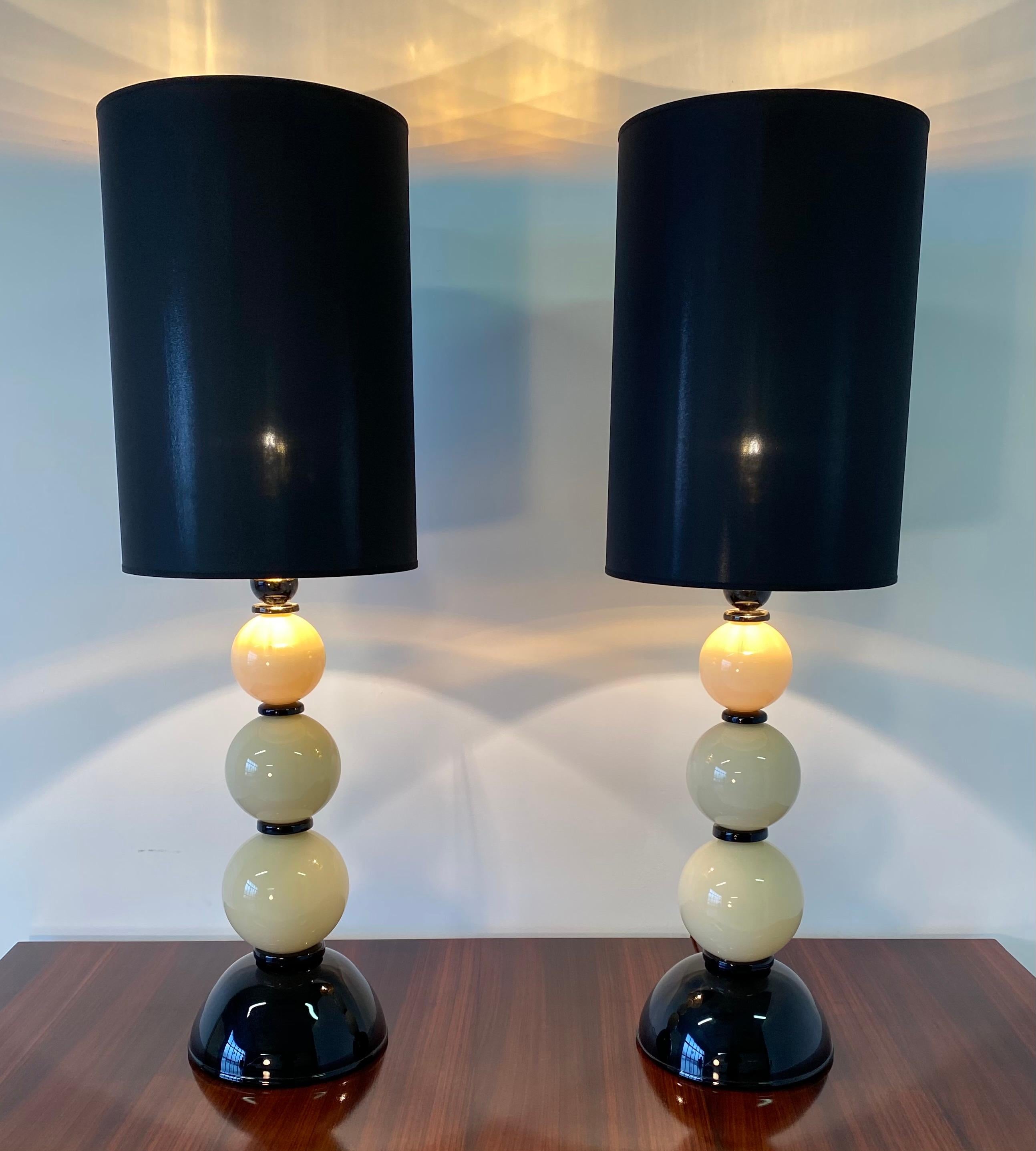 These lamps were produced in Murano in Italy, circa 2000s.
The lamps are entirely in pieces of Murano glass made by hand by master craftsmen.
The lampshades are in black silk while inside they are in gold so as to create a special and warm effect