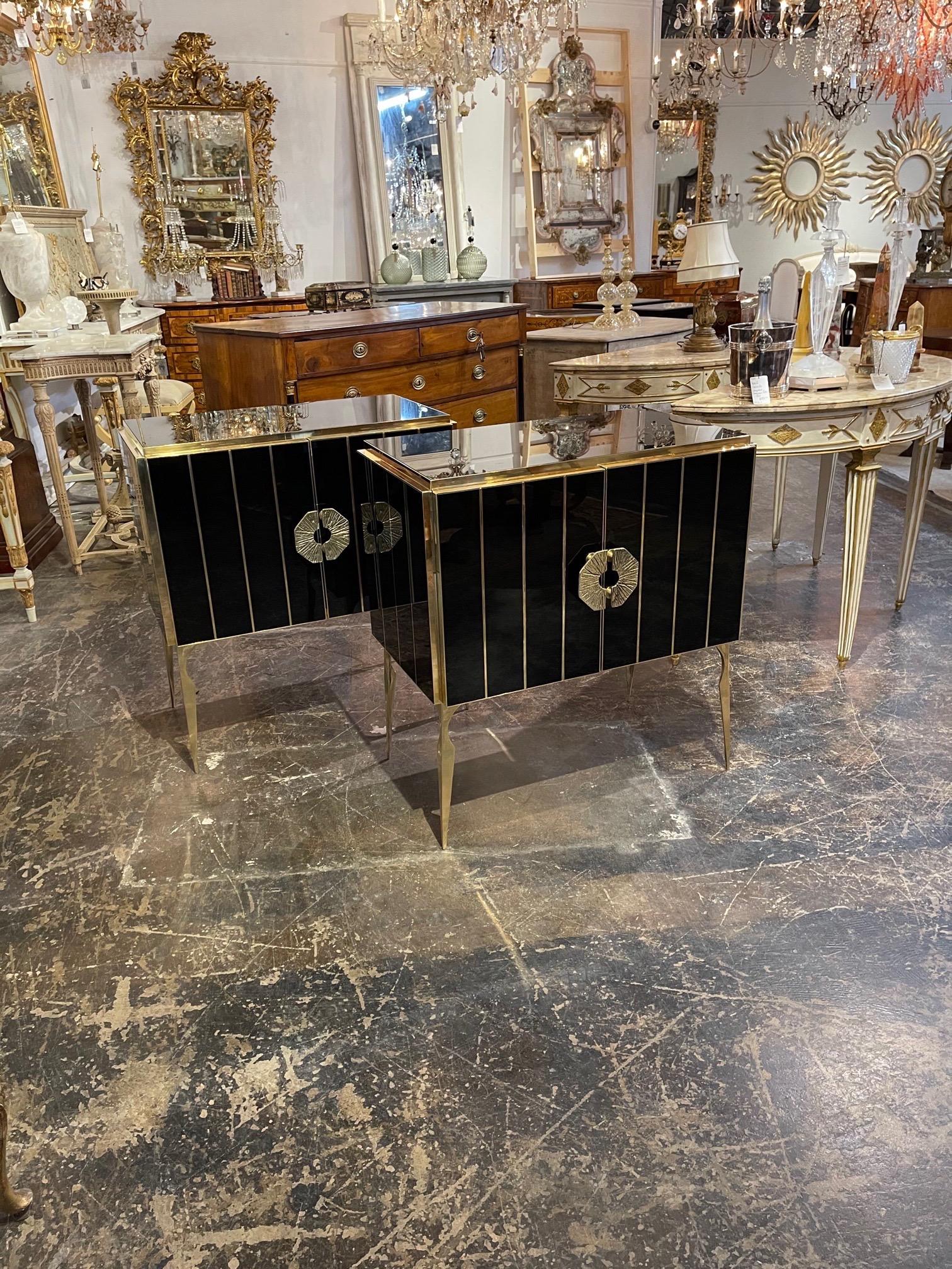 Very sleek pair of Murano glass and brass side tables. Creates an amazing polished look with the glistening black glass along with the decorative brass details and legs. Amazing!!