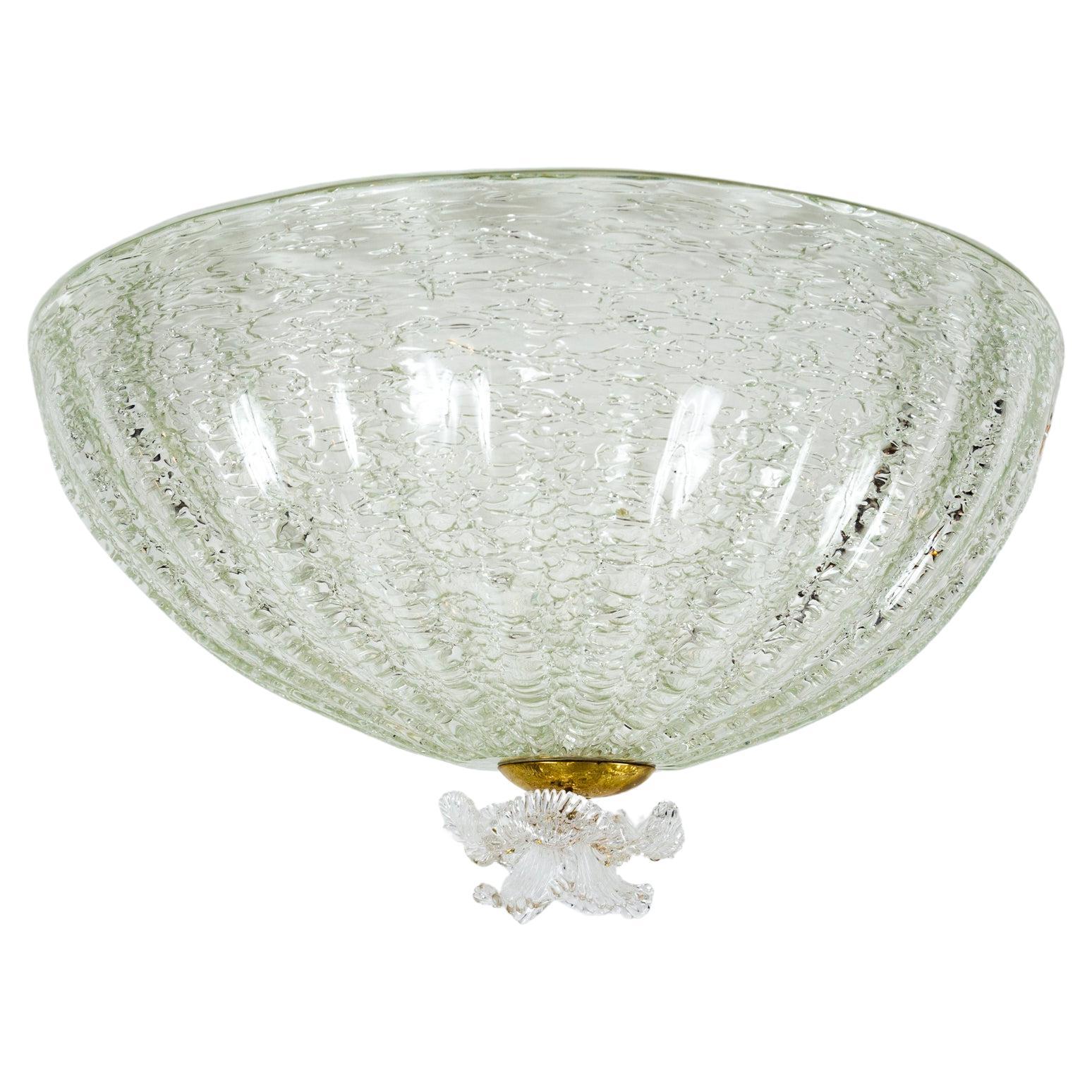 A beautiful pair of deep dome-shaped ceiling fixtures blown in a delicate and rare crackled technique with a delicate glass blown iris finial. Blown in a clear glass however the texture offsets the transparency.
The lamping is yet to be fabricated