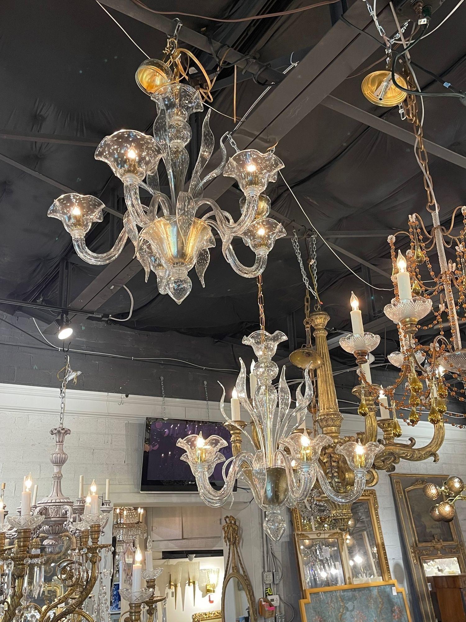 Pair of modern Murano gold bubble glass 5 light chandeliers. Circa 2000. These chandeliers hsvr been professionally re-wired, cleaned and are ready to hang. Includes matching chain and canopy. Sure to make a statement! Note: Sold as a pair.