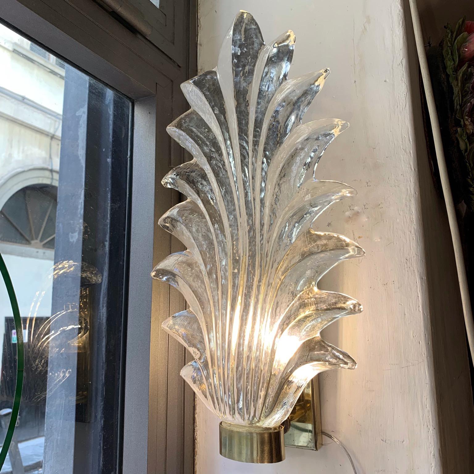 Pair of Murano clear glass leaf sconces, brass structure, one bulb per sconce.
The hand blown bright clear glass is thick and heavy.