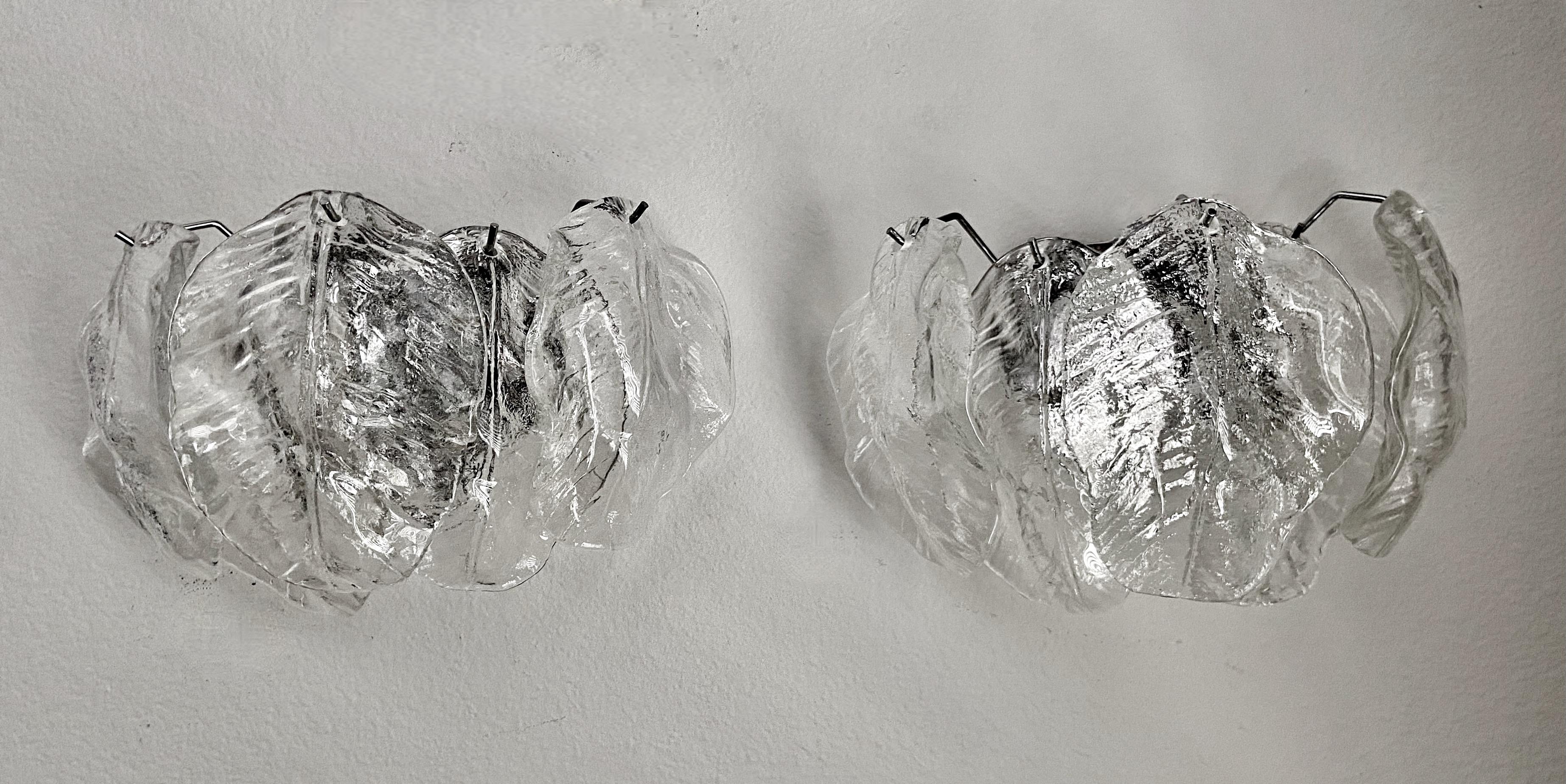 Pair of Italian Murano glass leaf shaped wall sconces with chrome plated backplates. Each sconce uses 2 candelabra base bulbs.