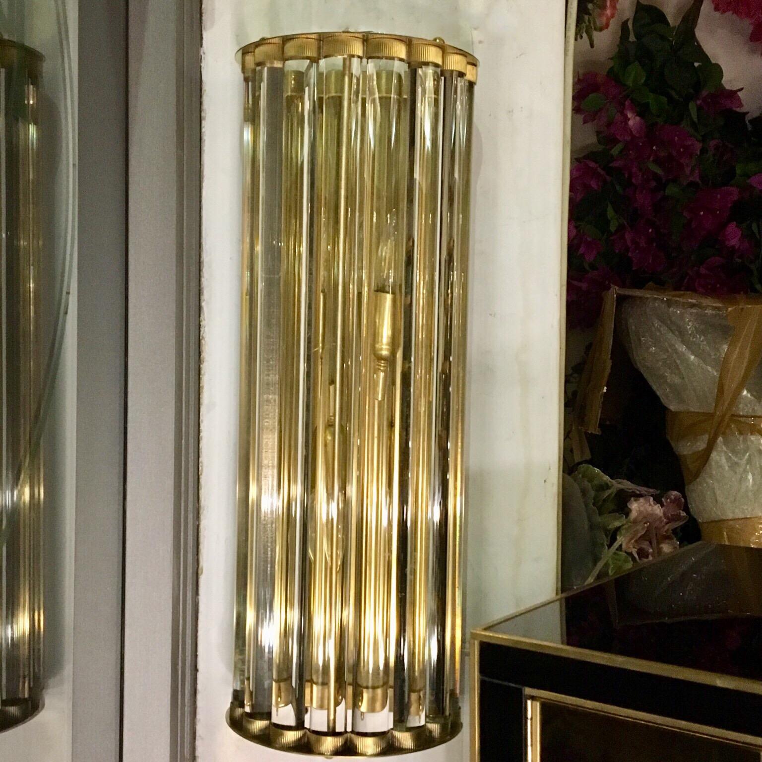 Pair of Murano clear glass wall sconces, half-round structure with hand blown transparent glass elements that are multiplying the light effect, brass structure. They can be positioned both horizontally and vertically, two bulbs per sconces, new