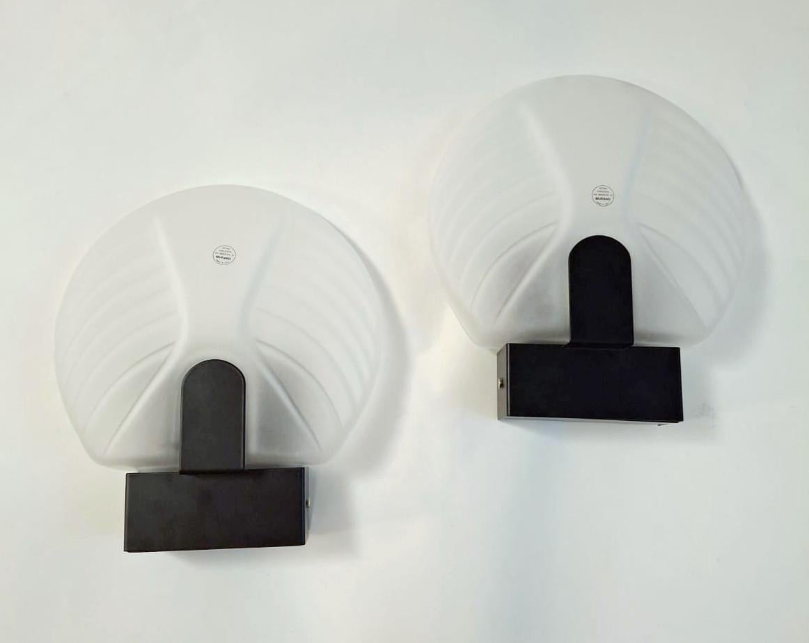 Vintage Italian wall lights with fan shaped satin frosted white Murano glass shades mounted on dark bronze metal frames / made in Italy, circa 1960s
Measures: height 13 inches, width 11 inches, depth 4 inches
1 light / E26 or E27 type / max 60W
1