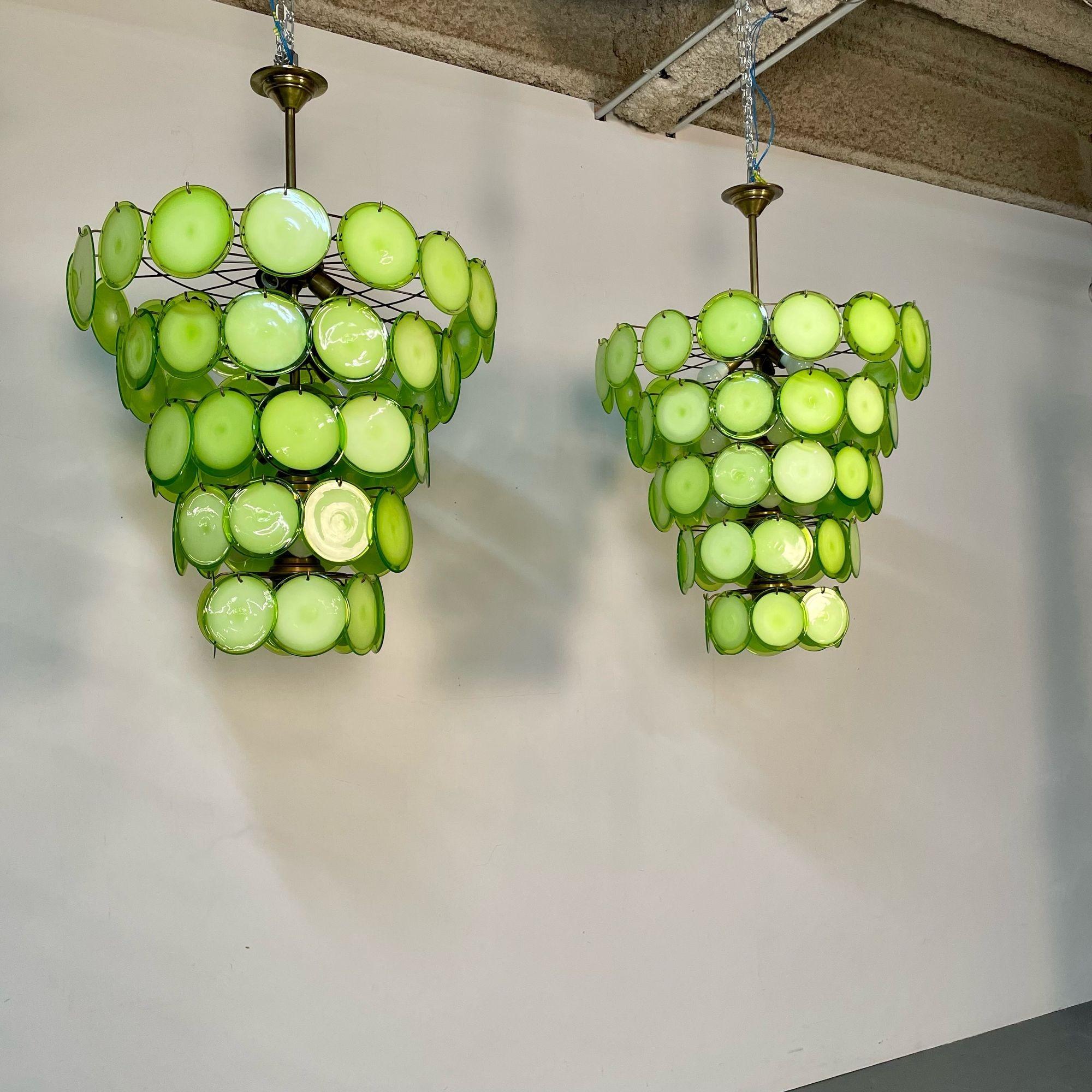 Pair Apple Green Murano Disc Mid-Century Modern Tiered Chandelier, Antiqued Brass, New Wired; Multiple Colors Avaiable
 
After purchasing a small factory of circa 1950/60s Murano Discs in Italy we have started to manufacture our own 2020 frames.
