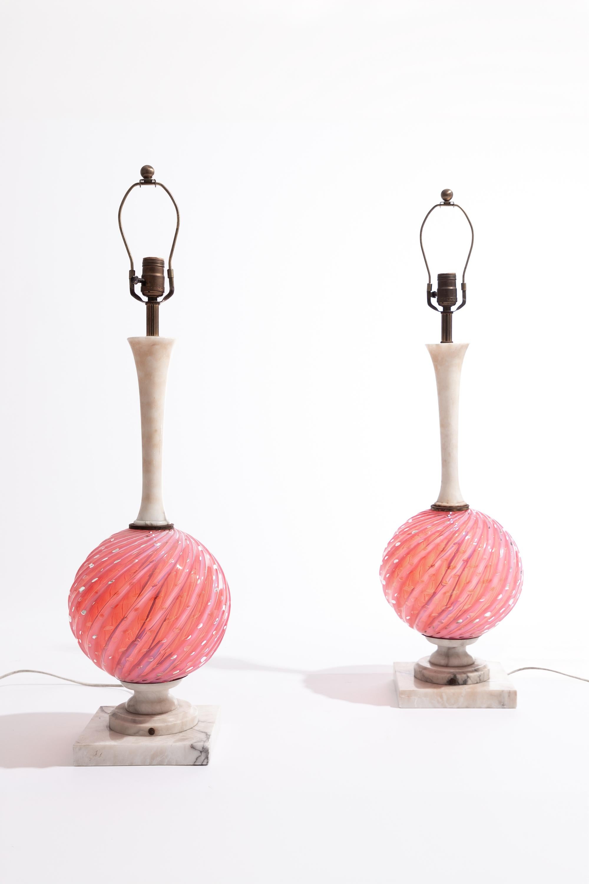 Sculptural pair of alabaster and Murano glass table Lamps. Italy, circa 1960.

Stepped alabaster base supporting a round blown glass ball in a swirling design with suspended bubble pattern and a slender alabaster column.

Dimensions: 70cm H to bulb