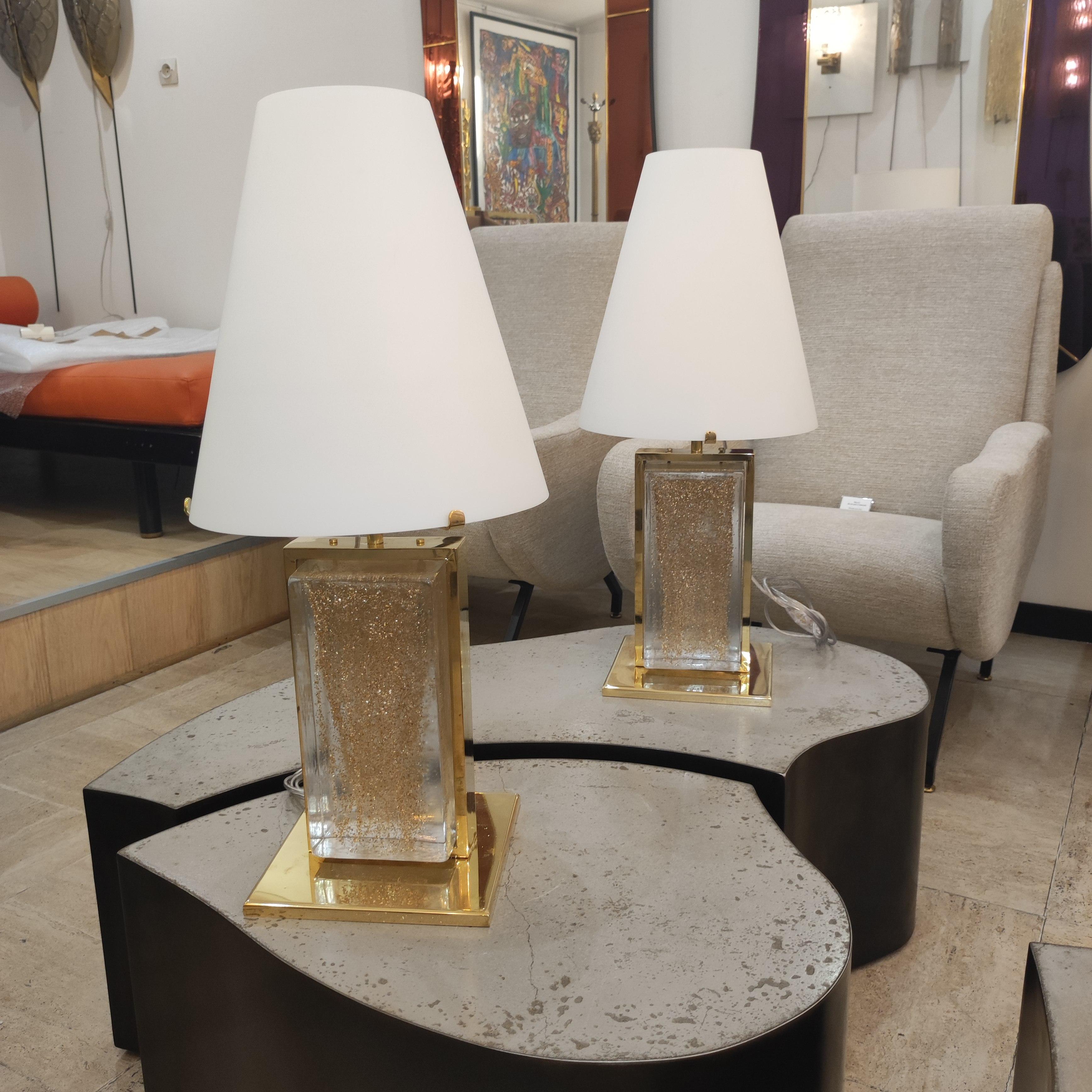 Pair of Murano glass and brass table lamp with white opaline glass lampshade.
the center is made of a block of glass with gold inlay
foot : 20x20cm.
 