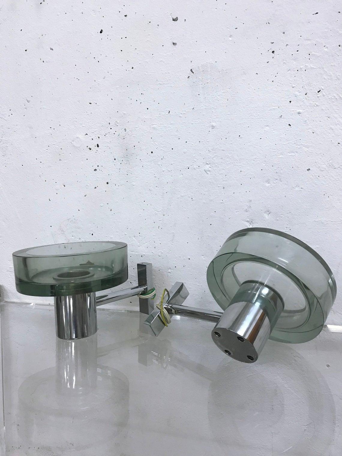 Pair of modernist Italian wall lights made of Murano glass and chrome-plated metal

The lamps were designed by Flavio Poli for Seguso in the 1960s

Lamps are unused

E27 lamp socket.
  