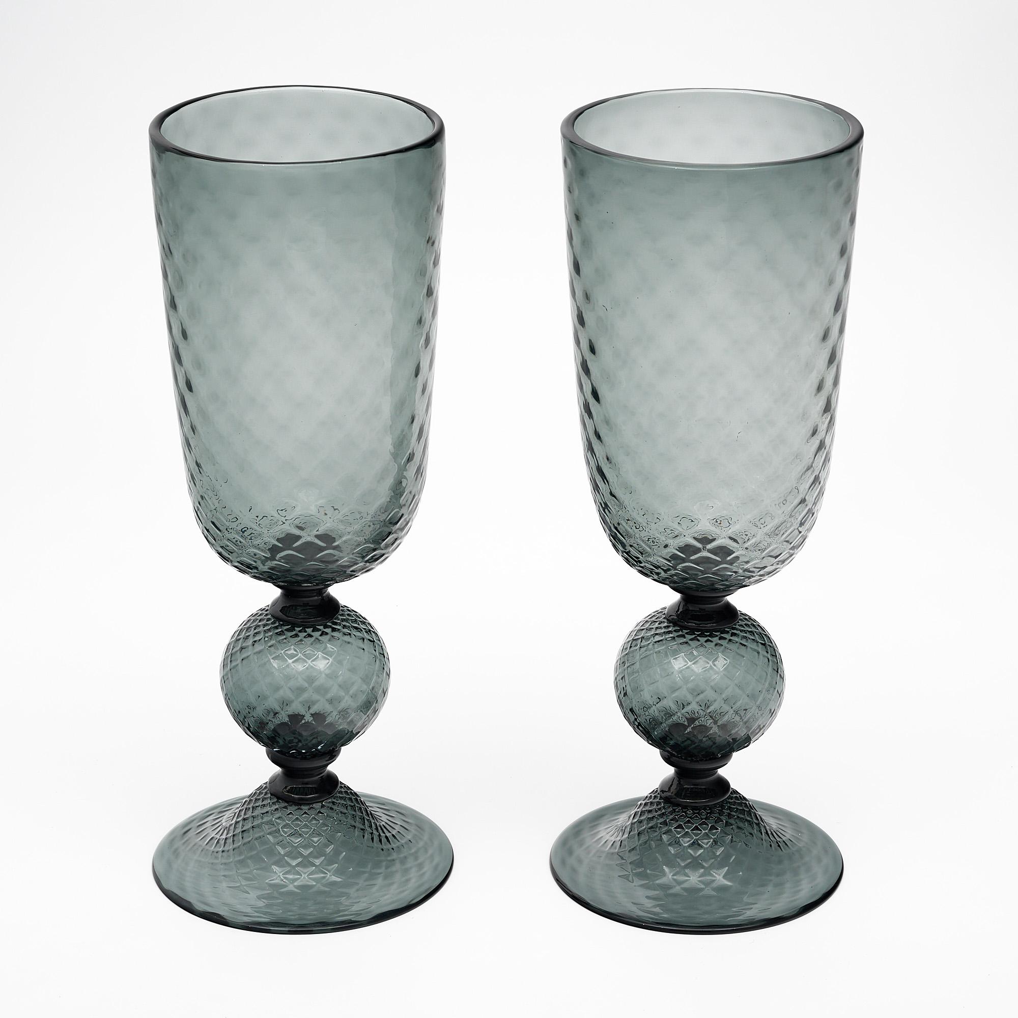 A pair of Murano glass urns made of hand blown glass in a charcoal gray tone. They are crafted in the “baloton” technique.