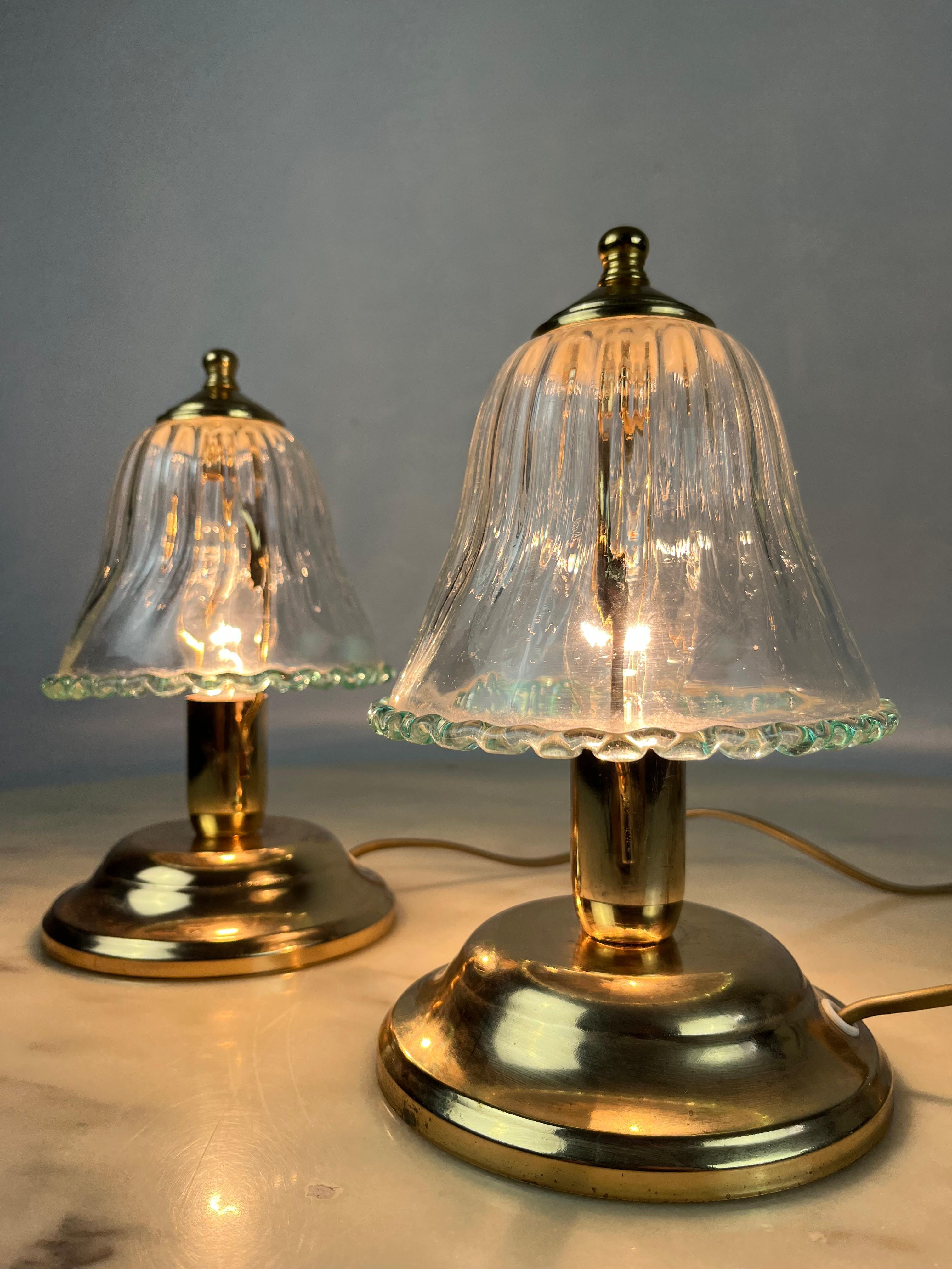 Pair of Murano glass bedside lamps, Italy, 1980s.
They have a structure in gilded metal. Intact and functioning.Small signs of time and use.