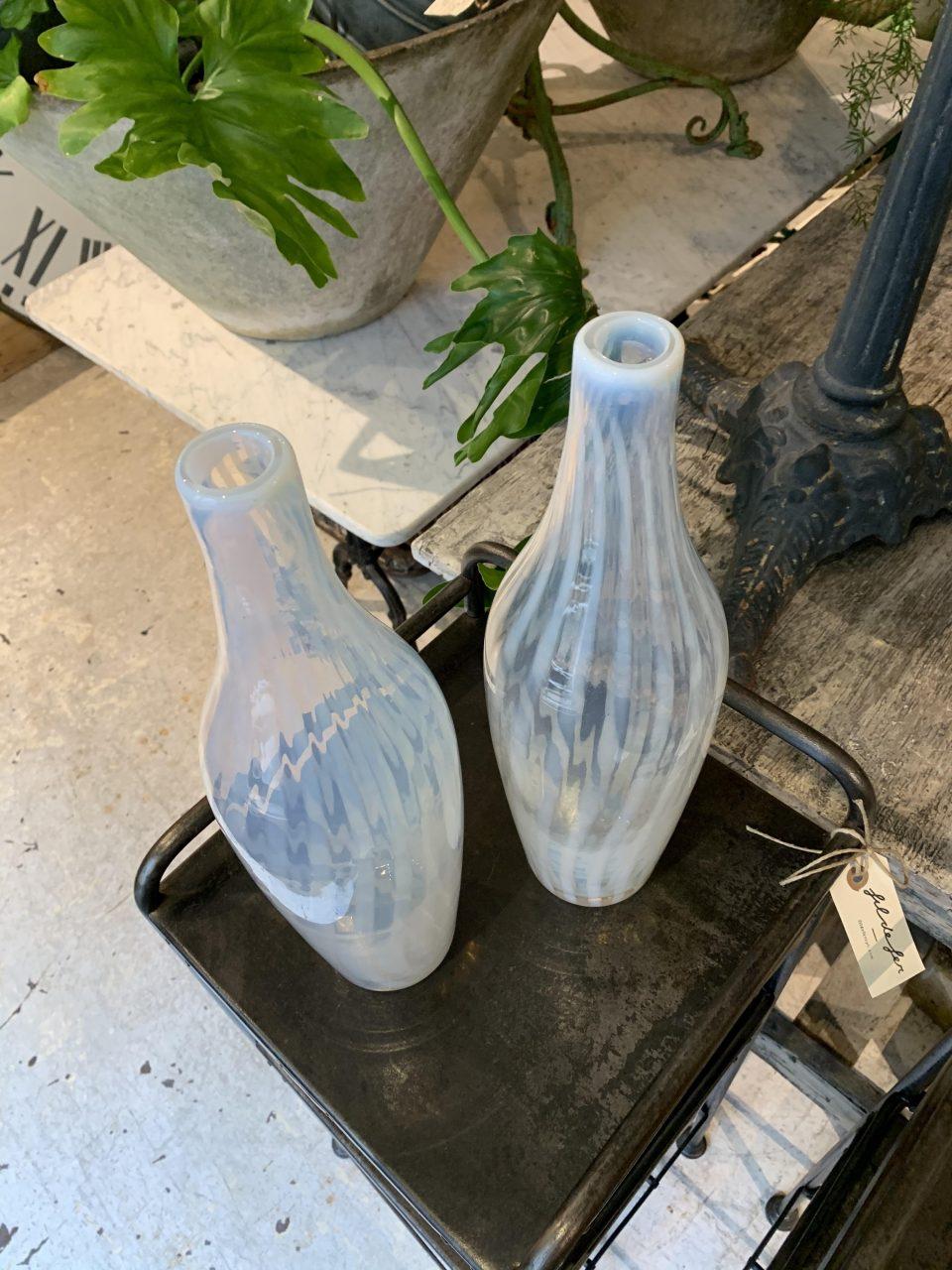 Lovely pair of tall slim and exceptionally beautiful semi-transparent hand blown glass vases, designed as elegant bottles. Produced around the 1960s on the world-famous island of Murano, a stone’s throw from the canal city of Venice in