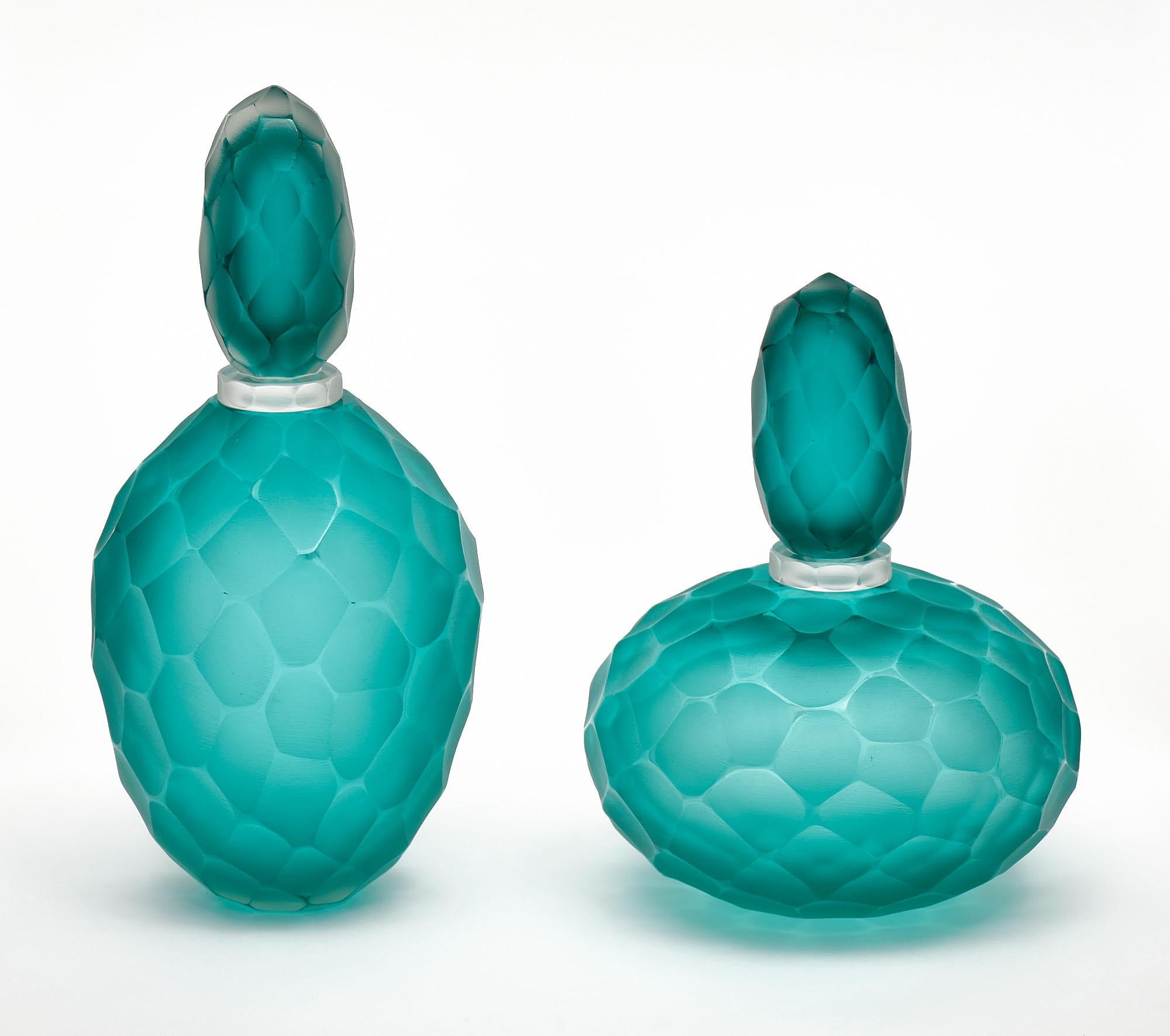 Pair of bottles made of hand-blown glass from Murano; Italy in the “Ferro Battuto” technique; attributed to Carlo Scarpa. This highly decorative pair is in a beautiful deep aqua blue color. 

Measures: Tall bottle
Height - 14”
Diameter -