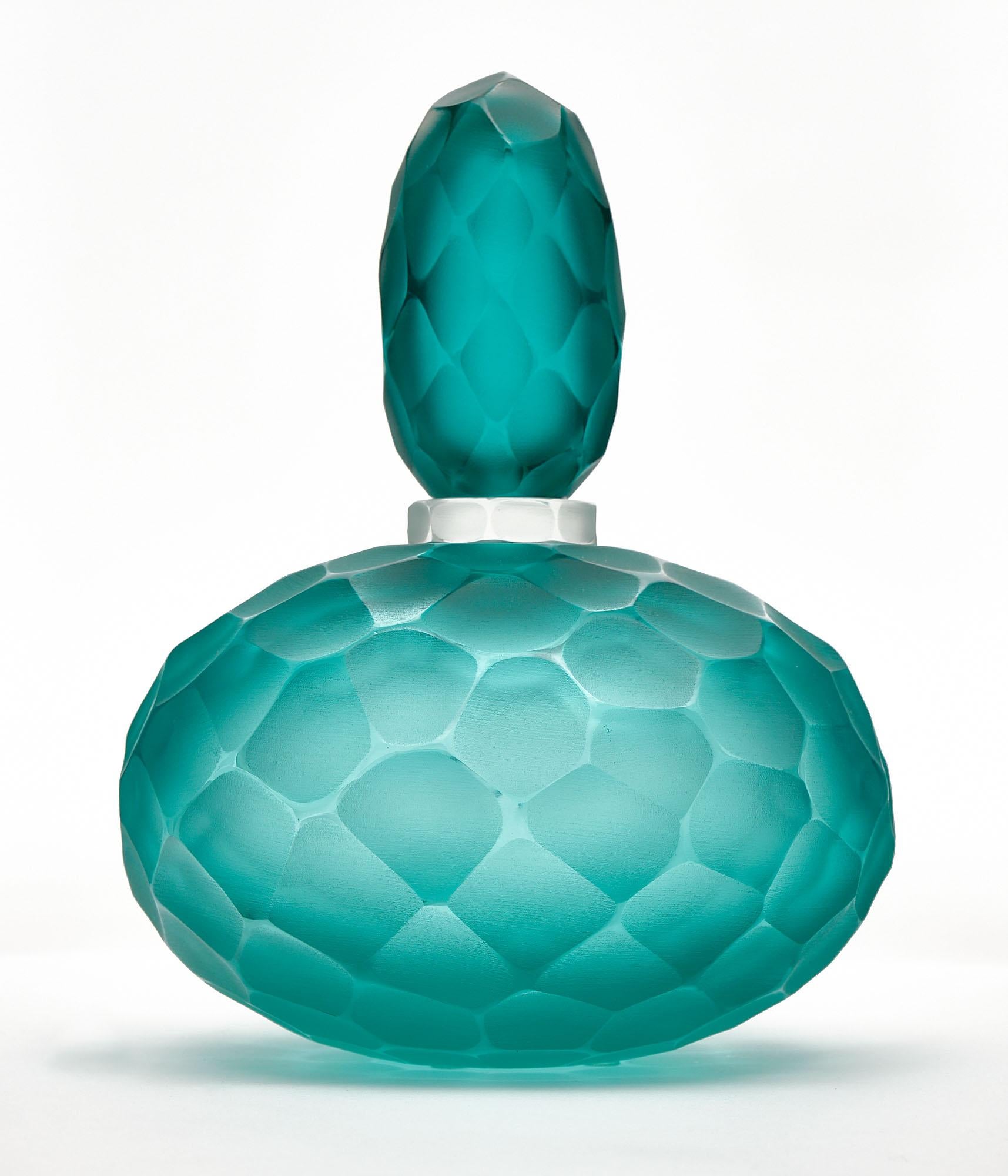 Pair of bottles made of hand-blown glass from Murano, Italy in the “Ferro Battuto” technique, attributed to Carlo Scarpa. This highly decorative pair is in a beautiful deep aqua blue color. 

Tall bottle
Height - 14”
Diameter - 6.5”

Short