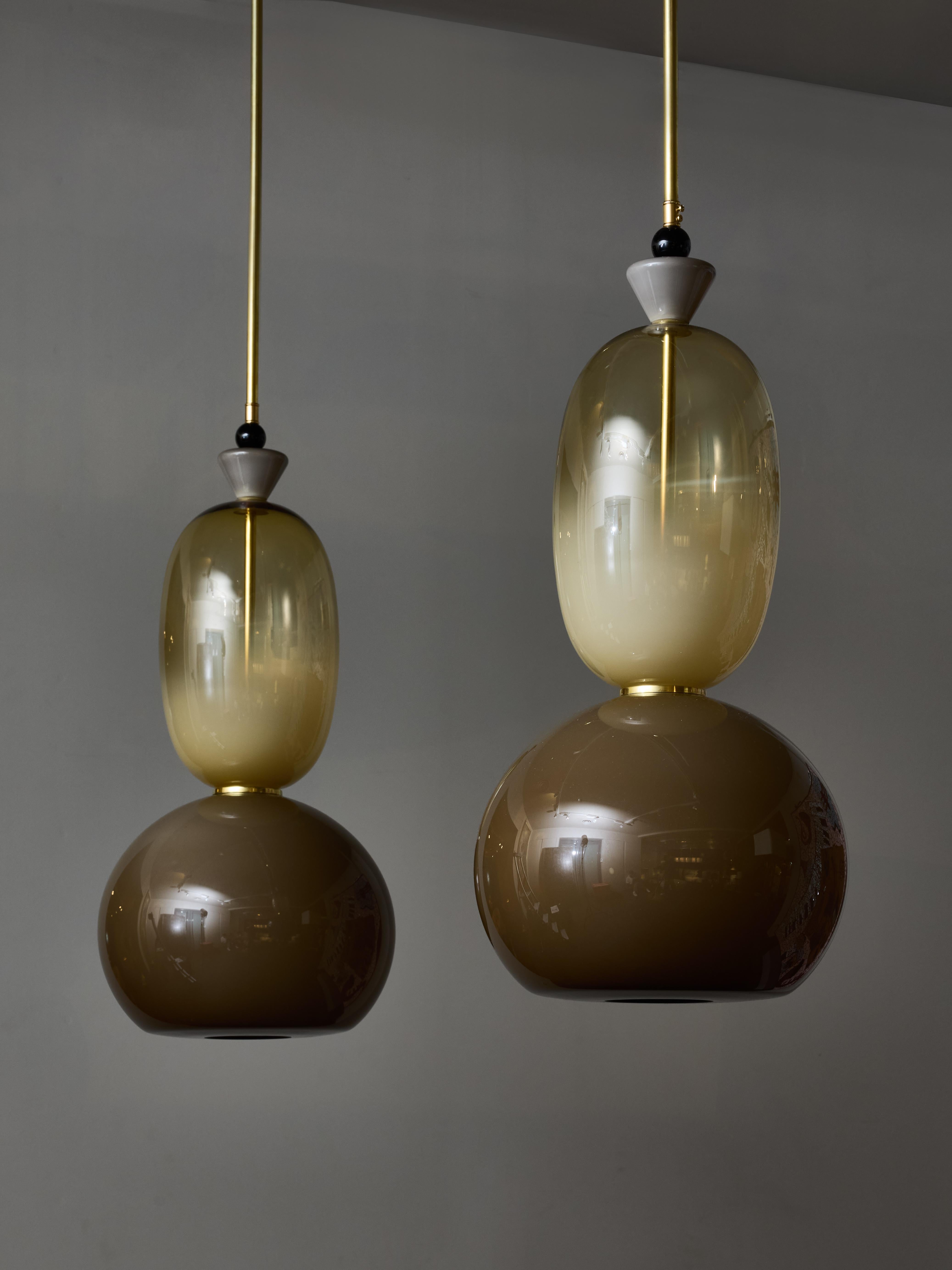 Pair of decorative suspensions made of a brass stem and a stack of different sized Murano glass globes and decors in various colours.

