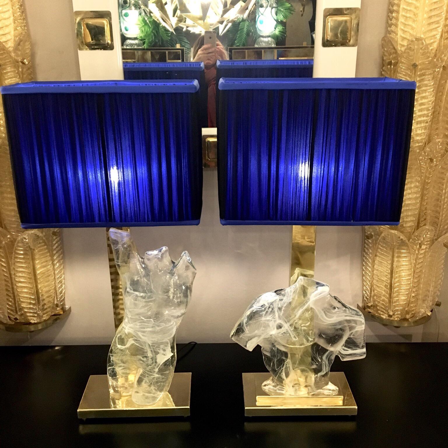 Pair of Murano clear glass lamps representing a masculine and feminine bust. The lamp consists in a Murano glass sculpture, solid and heavy made of clear Murano glass hand blown with filaments in opaque white glass, spider web effect.
The lamps have