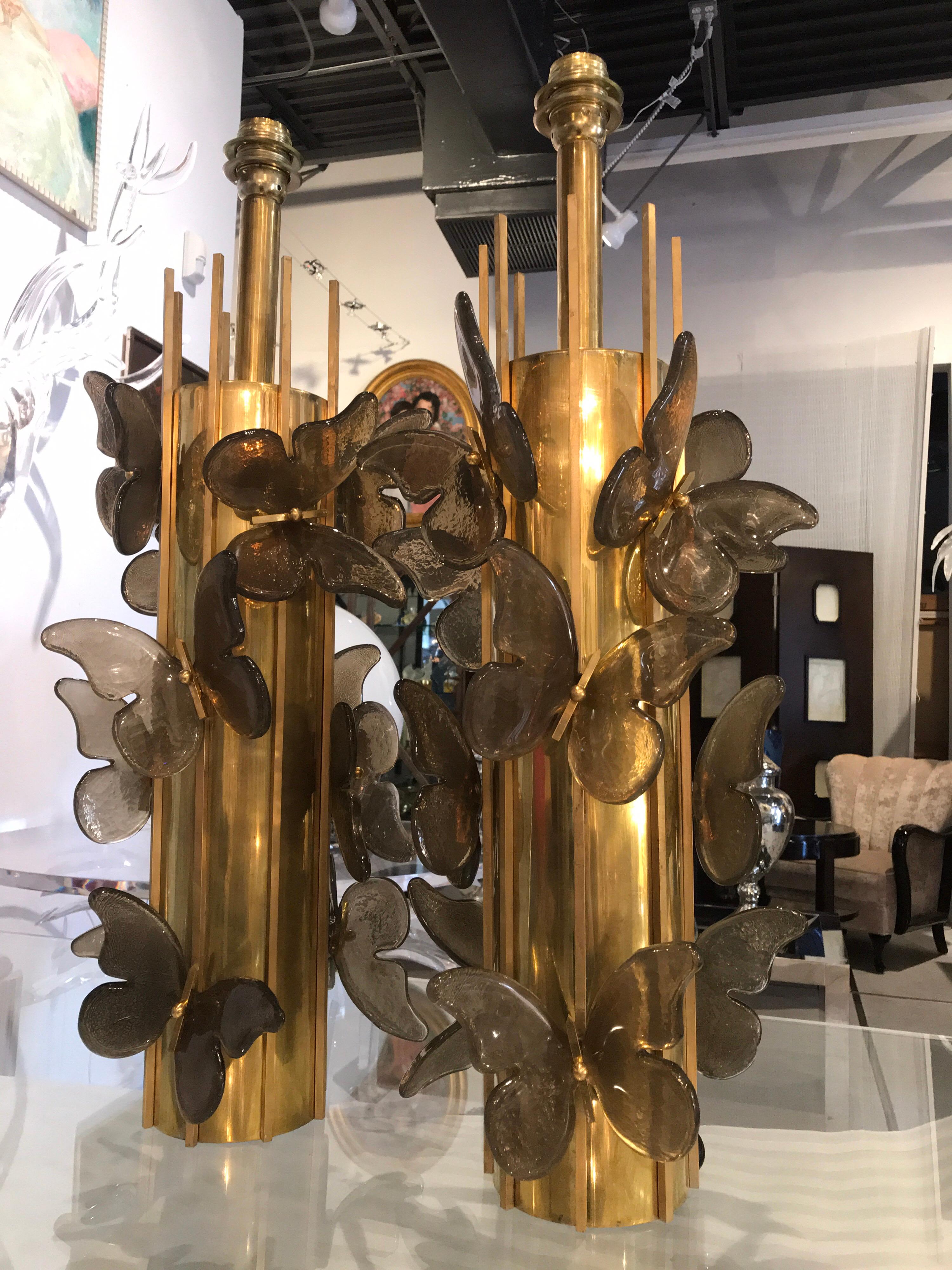 Beautiful topaz colored Murano glass butterflies adorn this pair of tubular brass table lamps. These unique and exquisite lamps can be rewired for the USA.