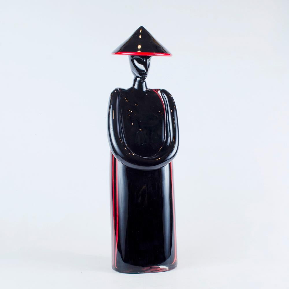 
Decorative sculptures made of black Murano glass and designed by Archimede Seguso in the 1960s. The objects is minimalist, delicate, and probably depicts a females subject of oriental origin.
A black, vintage Mid-Century Modern Italian pair of