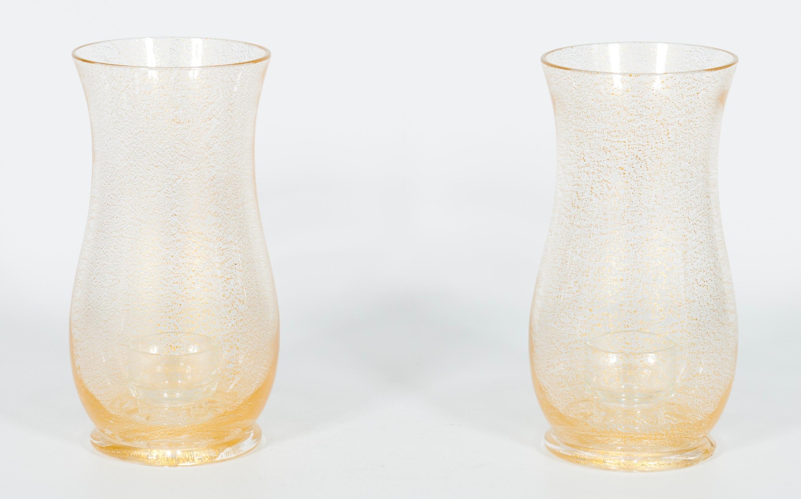 Pair of Murano glass candle holders with submerged gold, attributed to Striulli.
This unique set of two candle holders will bring beauty and elegance into your home. Entirely handcrafted in the 1980s in the Italian island of murano with transparent
