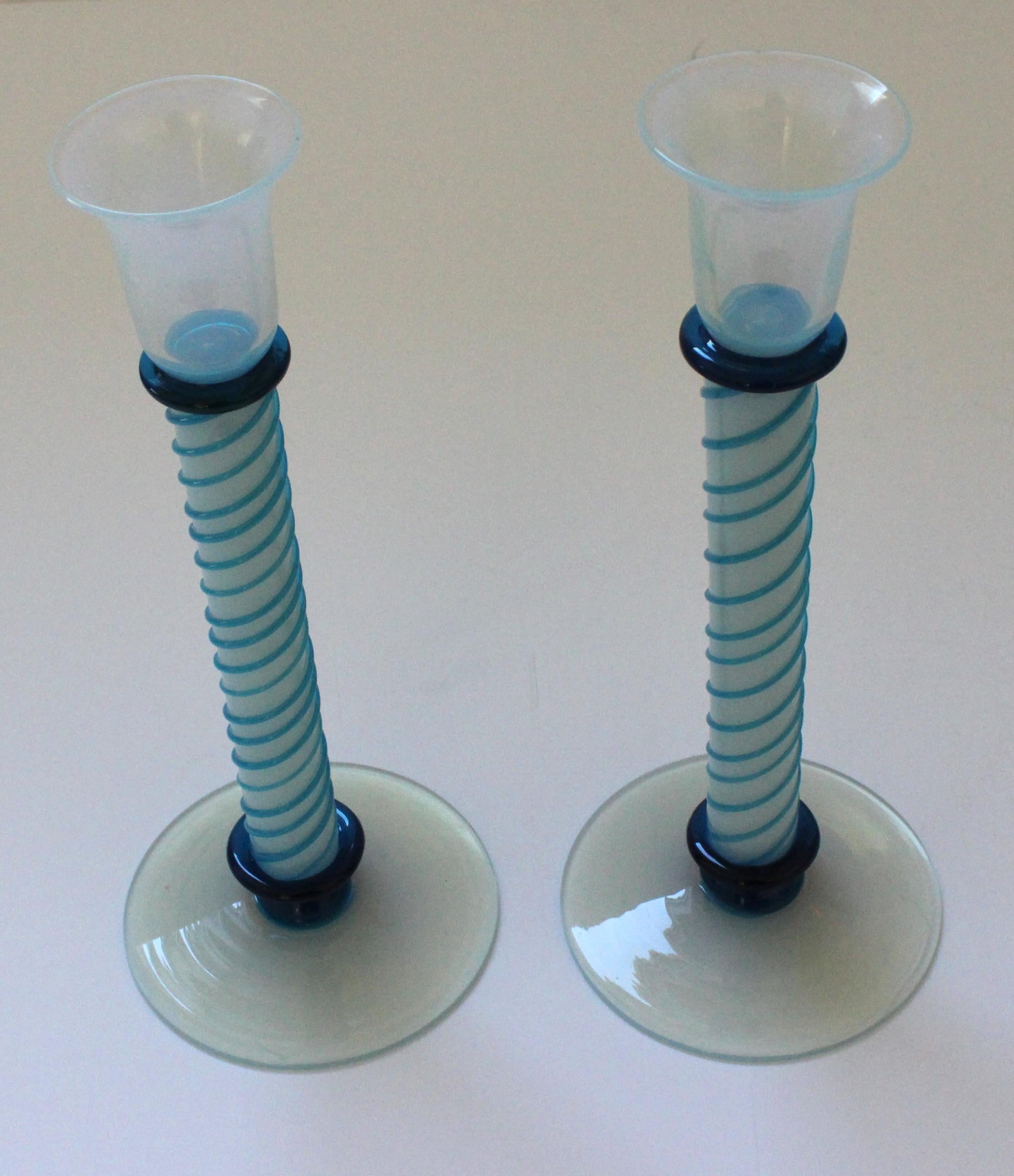This stylish and chic pair of Murano glass candlesticks will make a subtle statement with their colors of agean blue, turquoise and opalescent.

Note: Dimensions of one candlestick are 10.50