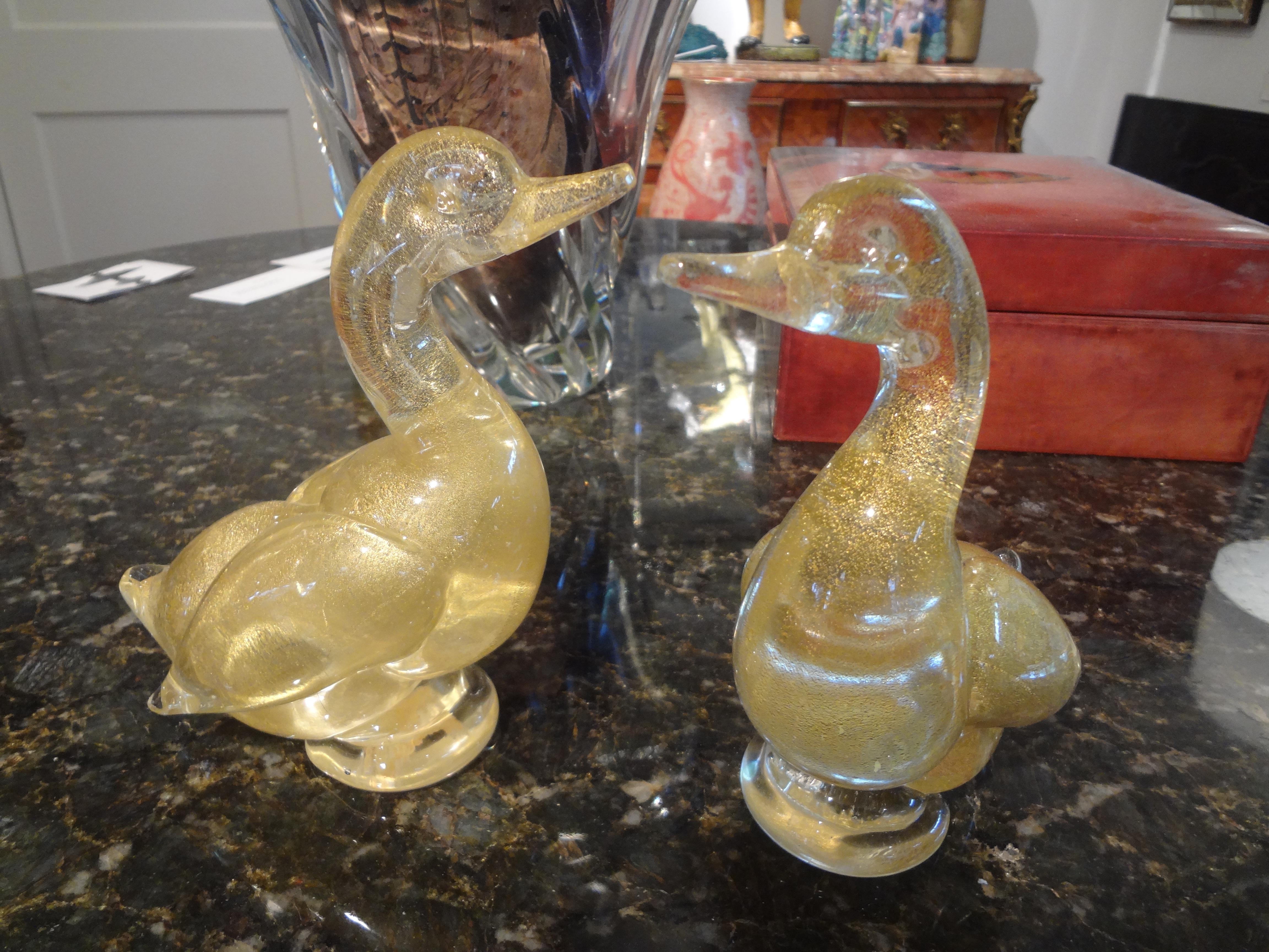 Pair of Murano glass ducks by Fratelli.
Beautiful pair of gold murano glass ducks by Fratelli. This lovely pair of murano glass ducks are a gold glass loaded with beautiful gold flecks. This pair of ducks retain what's left of the original label,