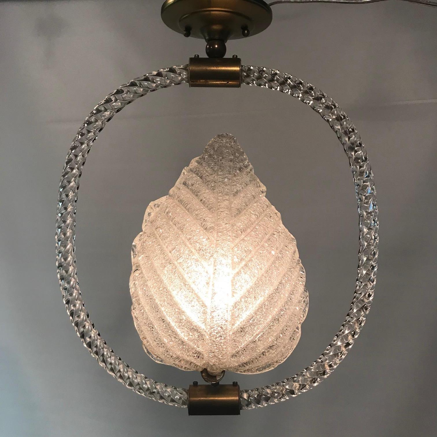 Pair of Moderne aventurine glass Murano leaf-form hanging fixtures each suspended in twisted glass rope circle by a brass shank, designed by Ercole Barovier for Barovier and Toso. 