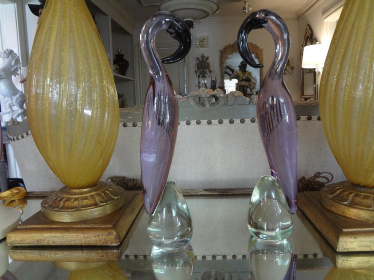 Stunning pair of lavender murano glass flamingo sculptures. This beautiful vintage pair of Italian Murano flamingos in a most unusual color was made in the mid-1950s by A Premier Glass House. Possibly Barovier, Seguso or Salviati.