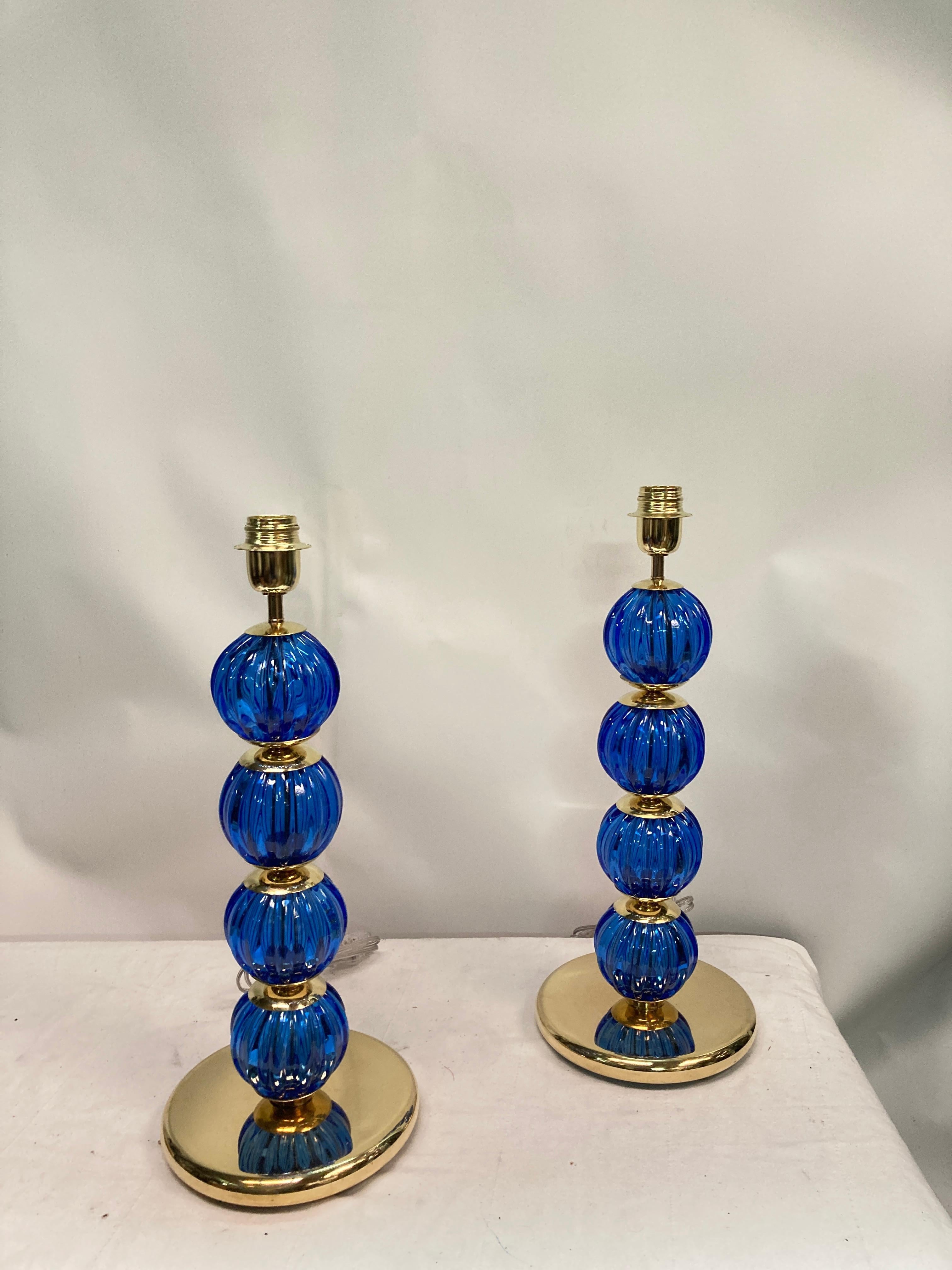 Pair of brass and Murano glass lamps 
in the style of Gino Cenedese
Nice condition
Dimensions given without shade
No shade included