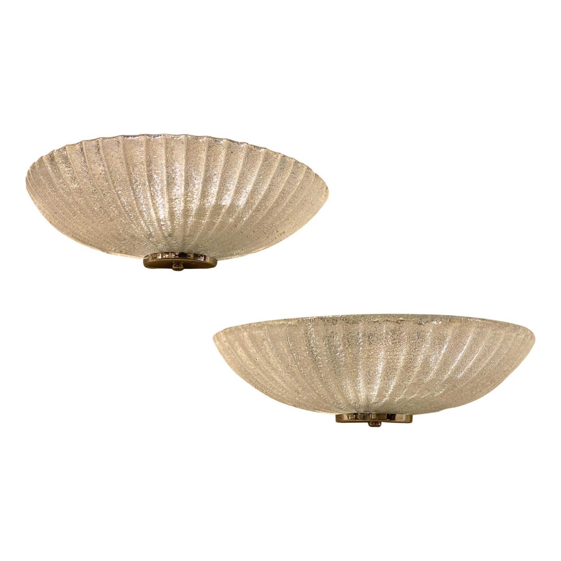 Pair of circa 1960's Italian glass wall sconces with nickel plated hardware.

Measurements:
Width 12