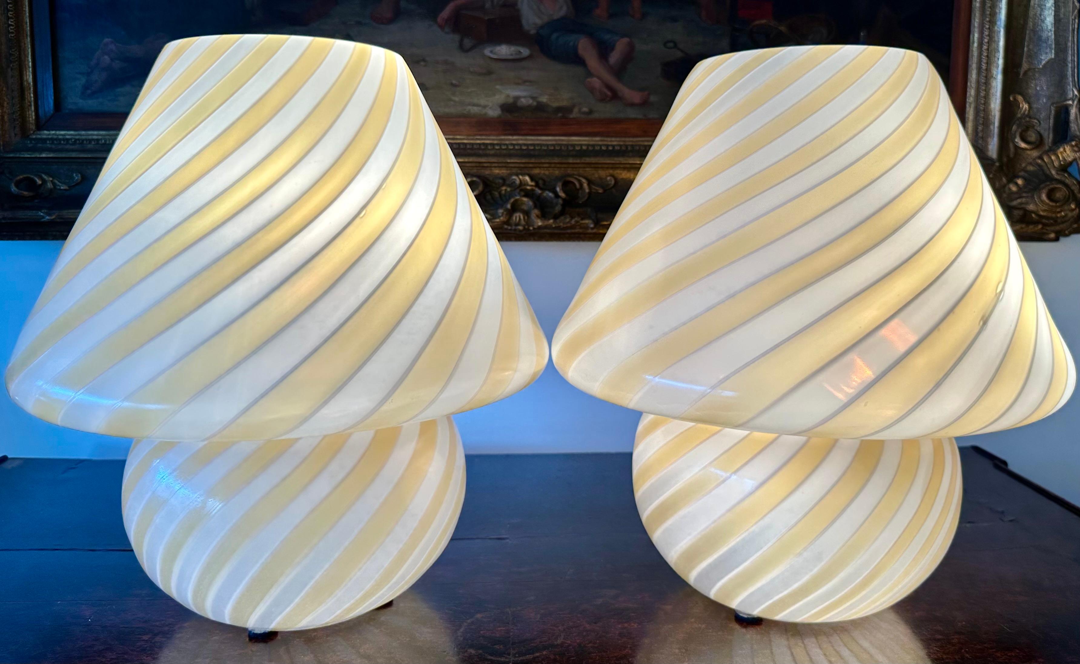Pair of murano glass mushroom table lamps, Italy, circa 1970.

The elegant shape of the murano post modernism with a swirl yellow and white lines makes this pair of murano table lamps a typical example of the 1970s glass blowing art. These lamps