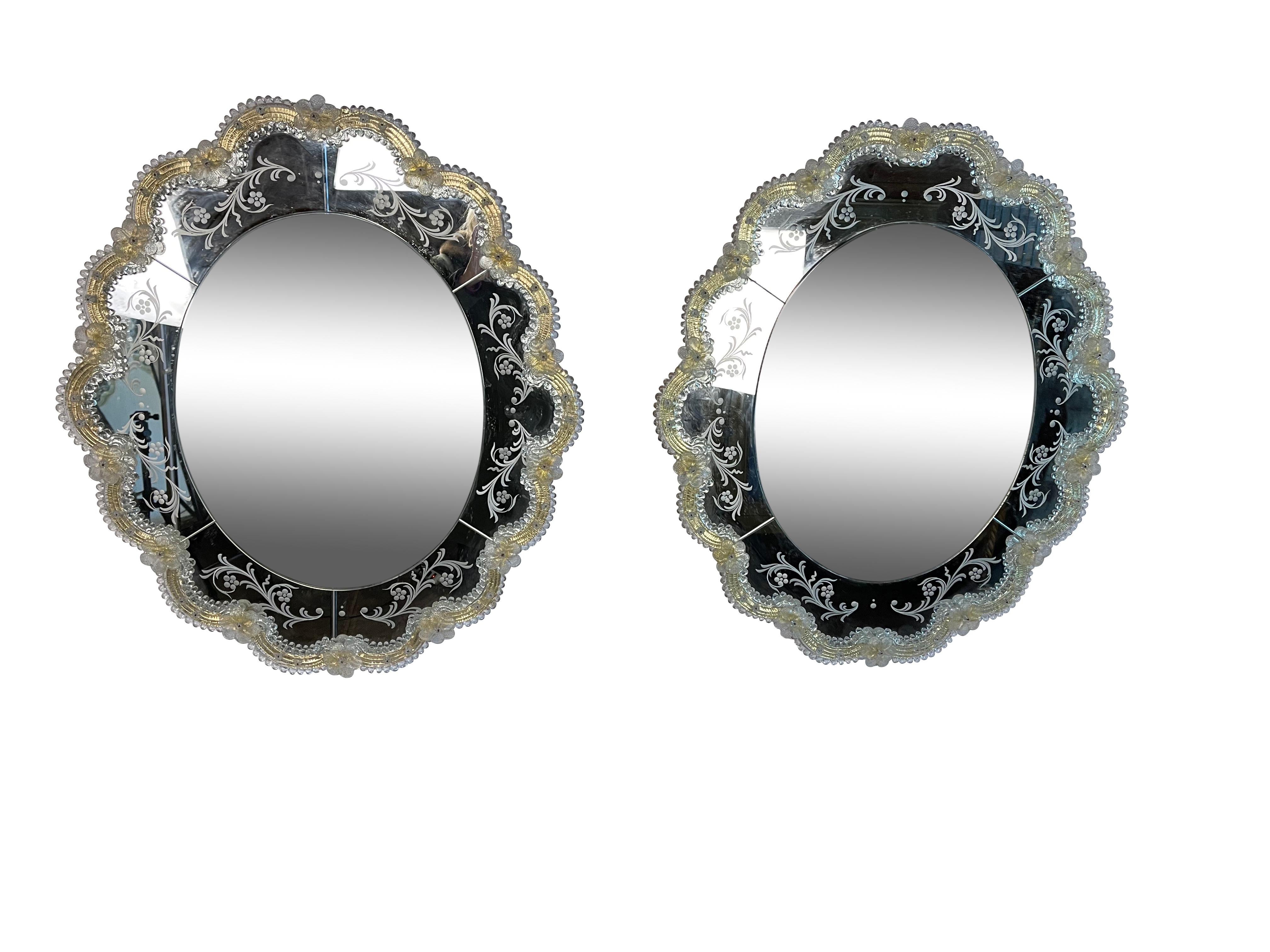 Pair of new Murano glass oval mirrors with gold glass accents. Finely etched with floral decoration measuring 27 H x 24 W x 1.50 D.