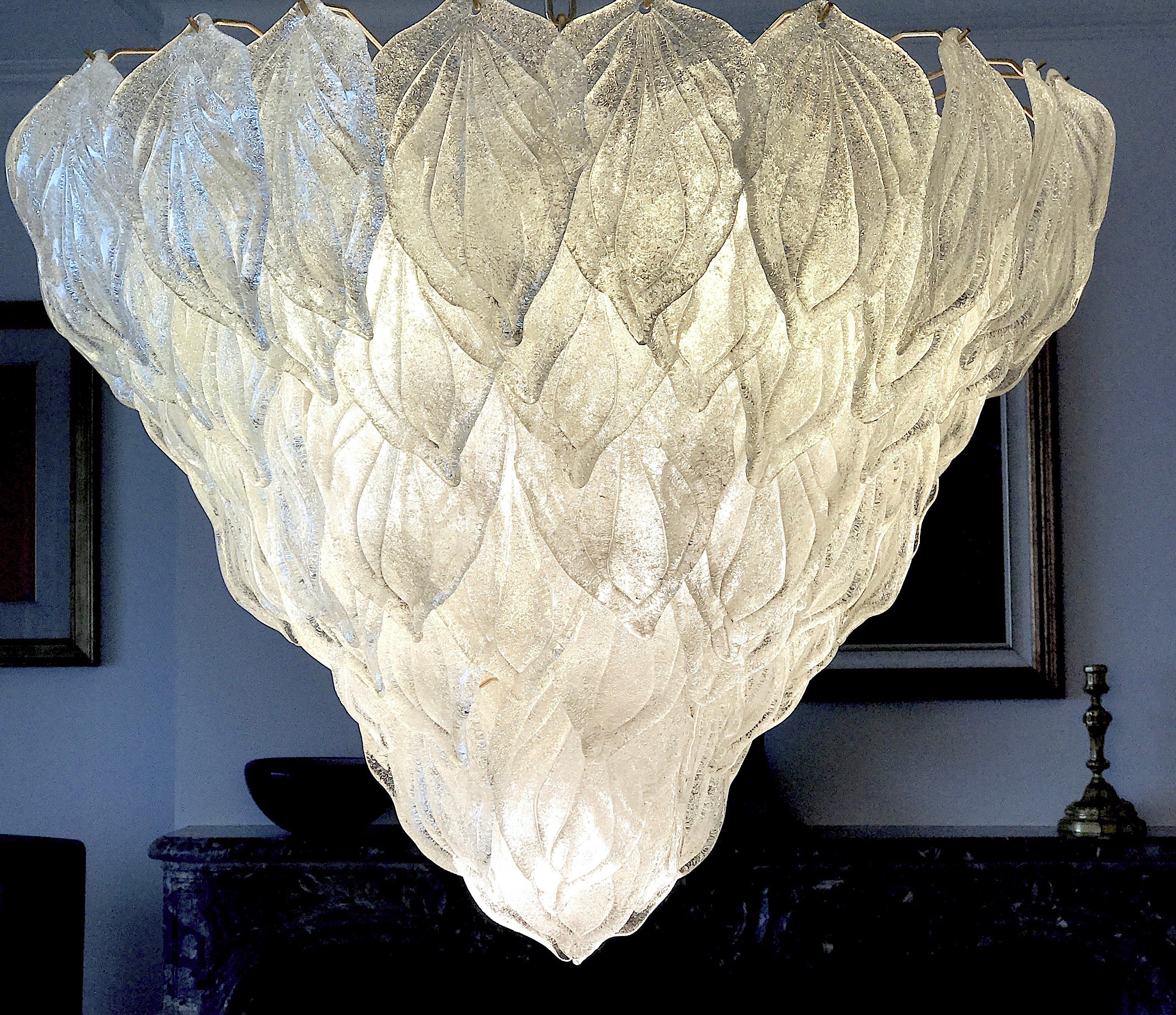 Murano polar ice color chandelier, each with 88 precious hand blown glass leaves hanging on the brass frame. Spectacular light effect.
Available three pairs of sconces.
Provenance from a Tuscany luxury hotel.
Measures: Height 75 cm, with chain