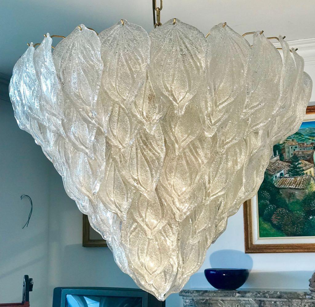 Murano polar ice color chandelier, each with 88 precious hand blown glass leaves hanging on the brass frame. Spectacular light effect.
Available three pairs of sconces.
Provenance from a Tuscany luxury hotel.
Measures: Height 75 cm, with chain 140