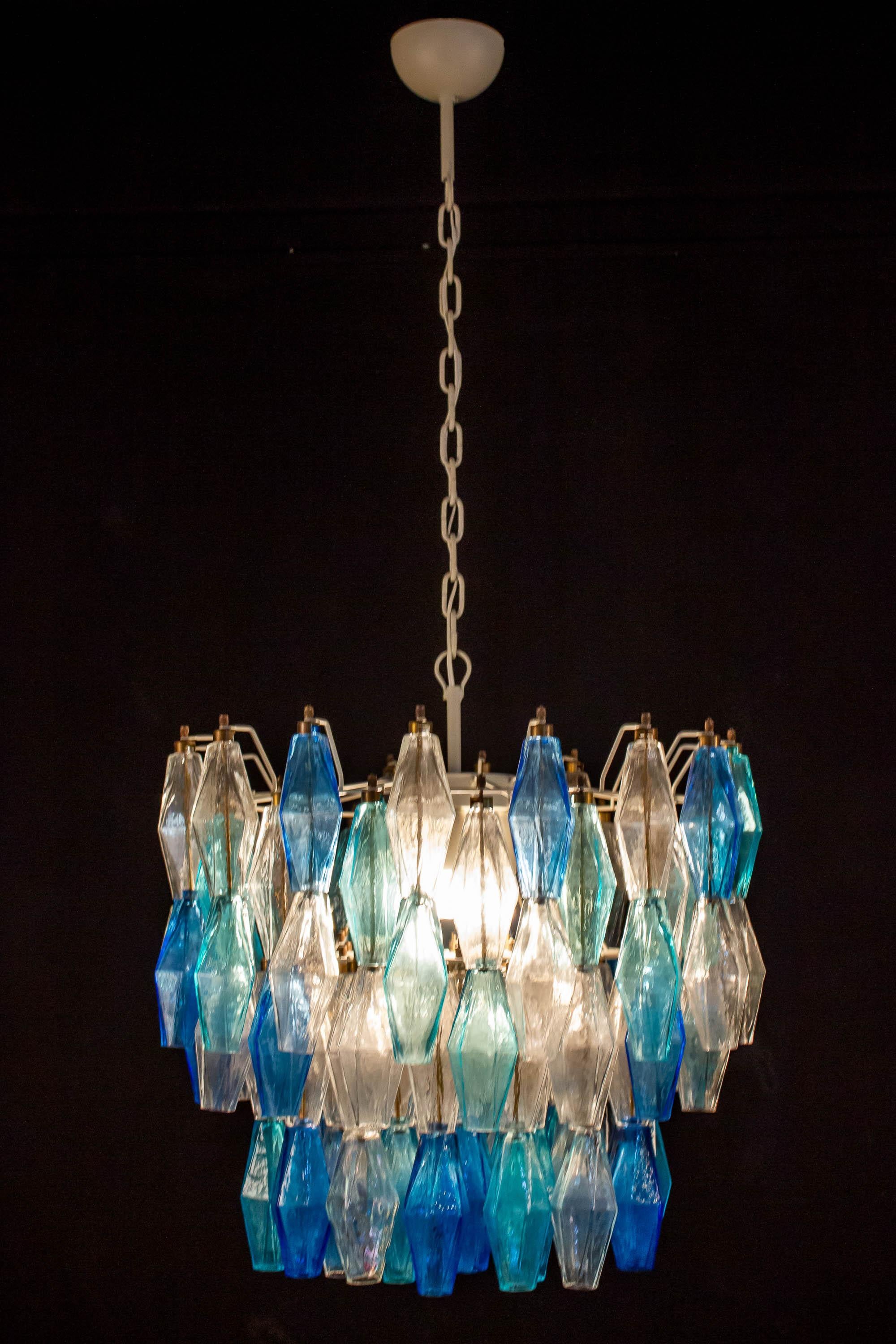 This fantastic pair of chandelier consists with 128 colored Poliedri glass of Murano.
Sapphire color variation with heavenly and aquamarine precious Poliedri.
Measures: Height without chain and canopy 50 cm (20 inches). With chain and canopy cm 110