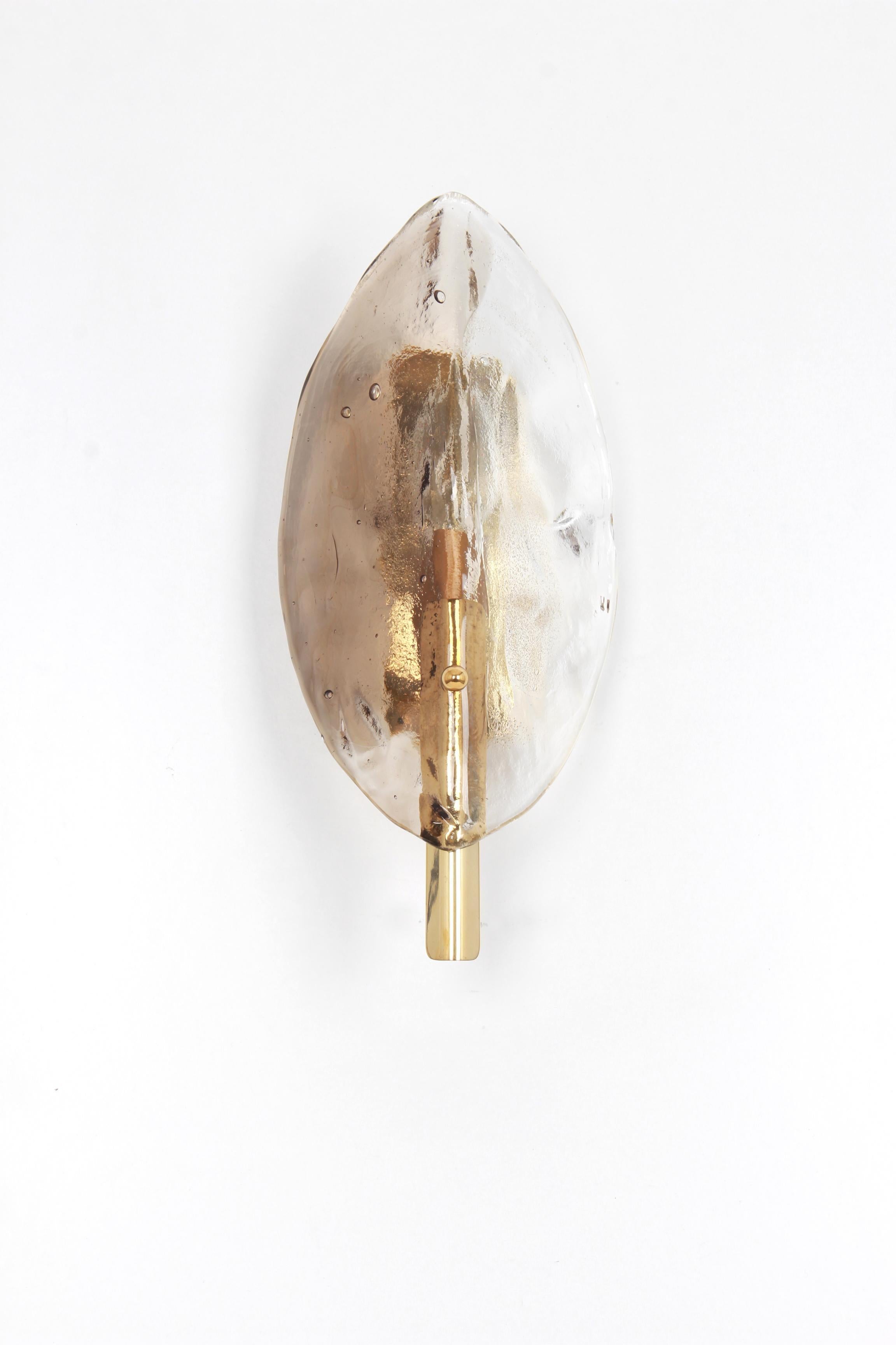 Wonderful mid-century wall sconce with handcrafted Smoked Murano glass piece on a brass base, made by J.T.Kalmar, Austria, manufactured, circa 1960-1969.
Model: Ficus

High quality and in very good condition. Cleaned, well-wired, and ready to