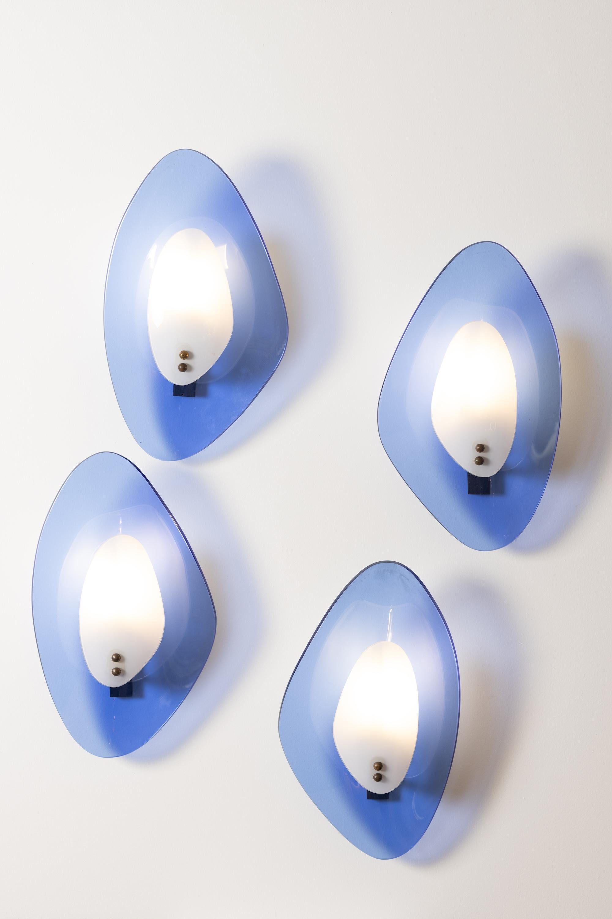 A striking example of mid-century Italian lighting, this rare set of four Murano glass sconces embodies both sculptural artistry and timeless elegance. Hand-blown in Murano during the 1960s, each fixture presents an organic, asymmetrical form