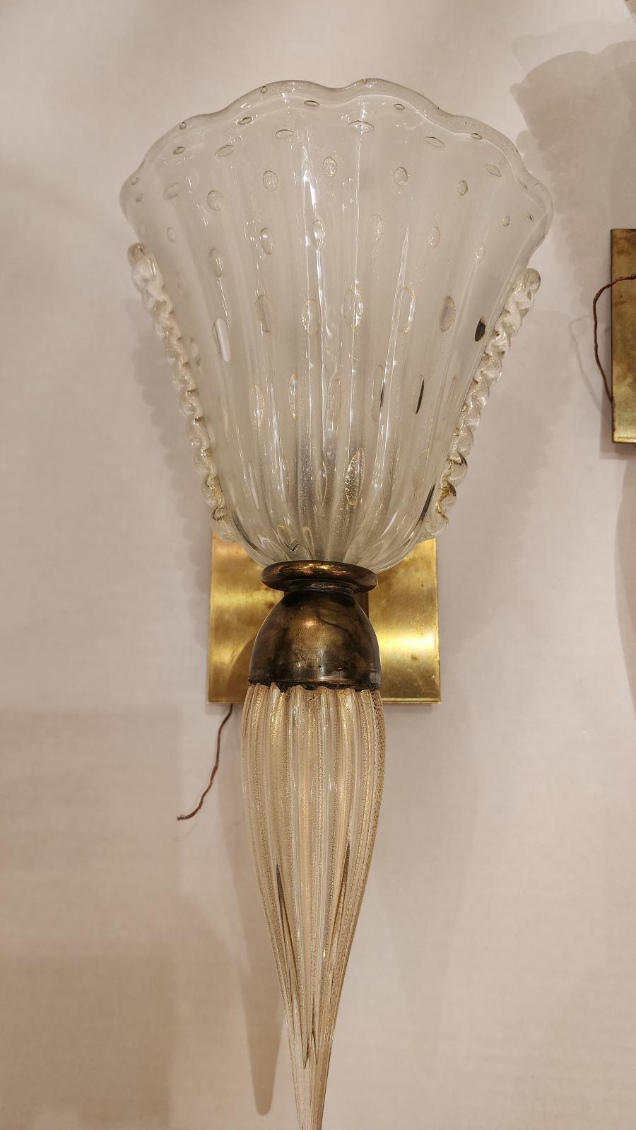 This listing features a pair of Murano-style glass sconces. This wall light was made by hand with great care and attention to detail, gracefully curved and had beautiful designs subtle but enough to draw the eye in. The top part of the fixture is