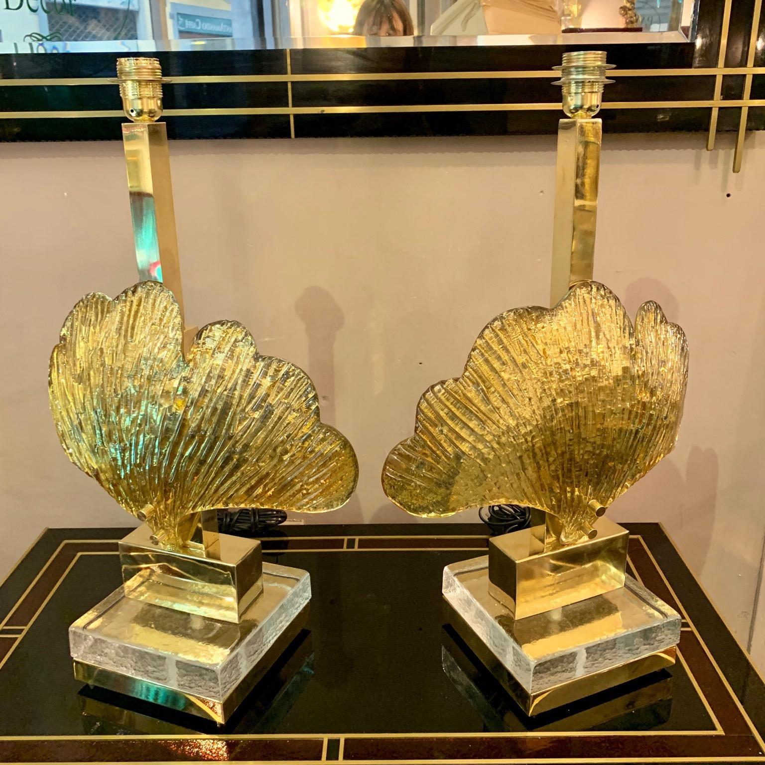 Pair of Murano glass shell table lamps gilt mirrored leaves, brass structure, rectangular clear Glass base, one bulb per lamps. We realize handcrafted lampshades with customized designs.