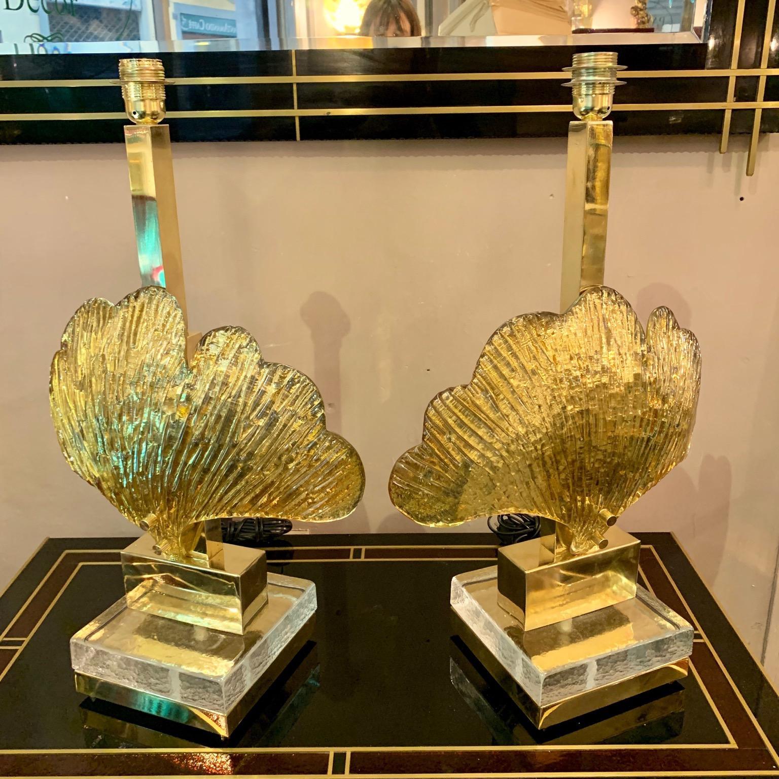 Pair of Murano glass shell table lamps gilt mirrored leaves, brass structure, rectangular clear glass base, one bulb per lamps. We realize handcrafted lampshades with customized designs.