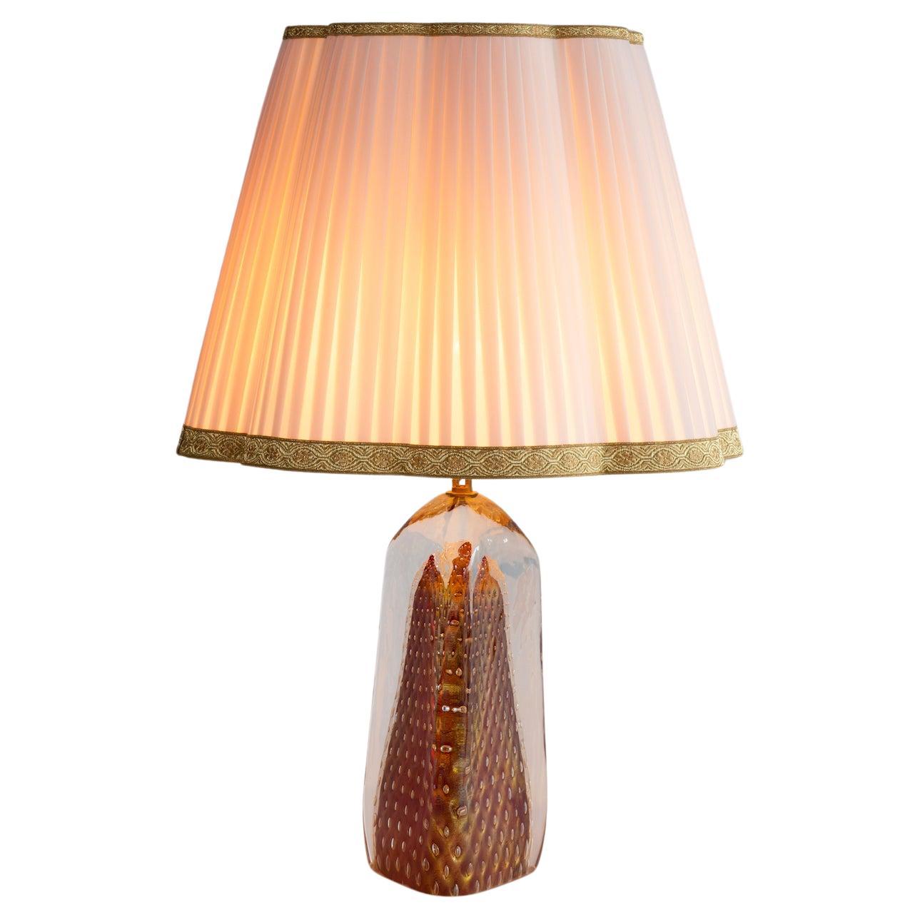 Dramatic Pair of Murano Glass Table Lamps, 1990s - Gold Submerged & Ruby Radiance

Illuminate your space with the striking allure of this exceptional pair of Murano glass table lamps, a bold statement of 1990s design. These lamps are not merely