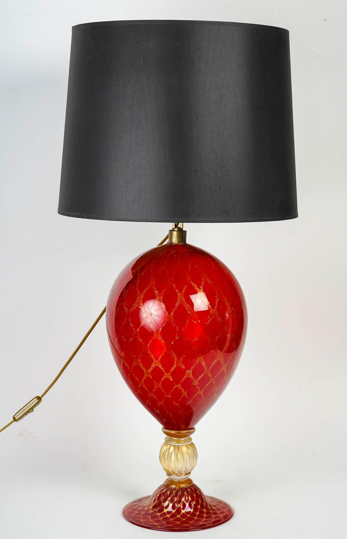 Pair of Murano Glass Table Lamps, Circa 1950.

Pair of table lamps in red Murano glass with gold thread, circa 1950.
Total: h: 82cm, d: 40cm
Lamp base: h: 61cm, d: 21cm