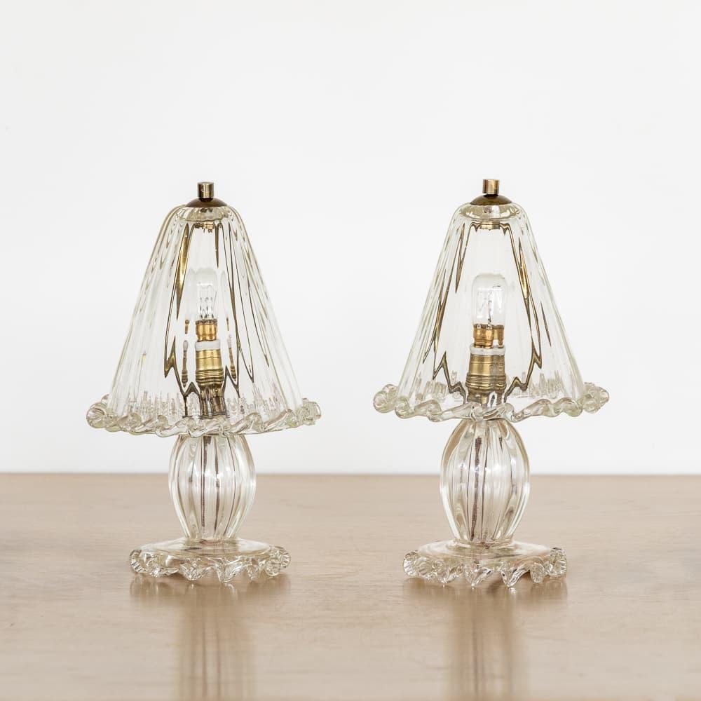 Stunning pair of petite Murano glass lamps from Italy, 1940s. Beautiful blown glass bell shade with scalloped trim, bulbous glass body, and circular glass base with wavy scalloped trim. Beautiful age and patina to the brass details. Newly rewired.
