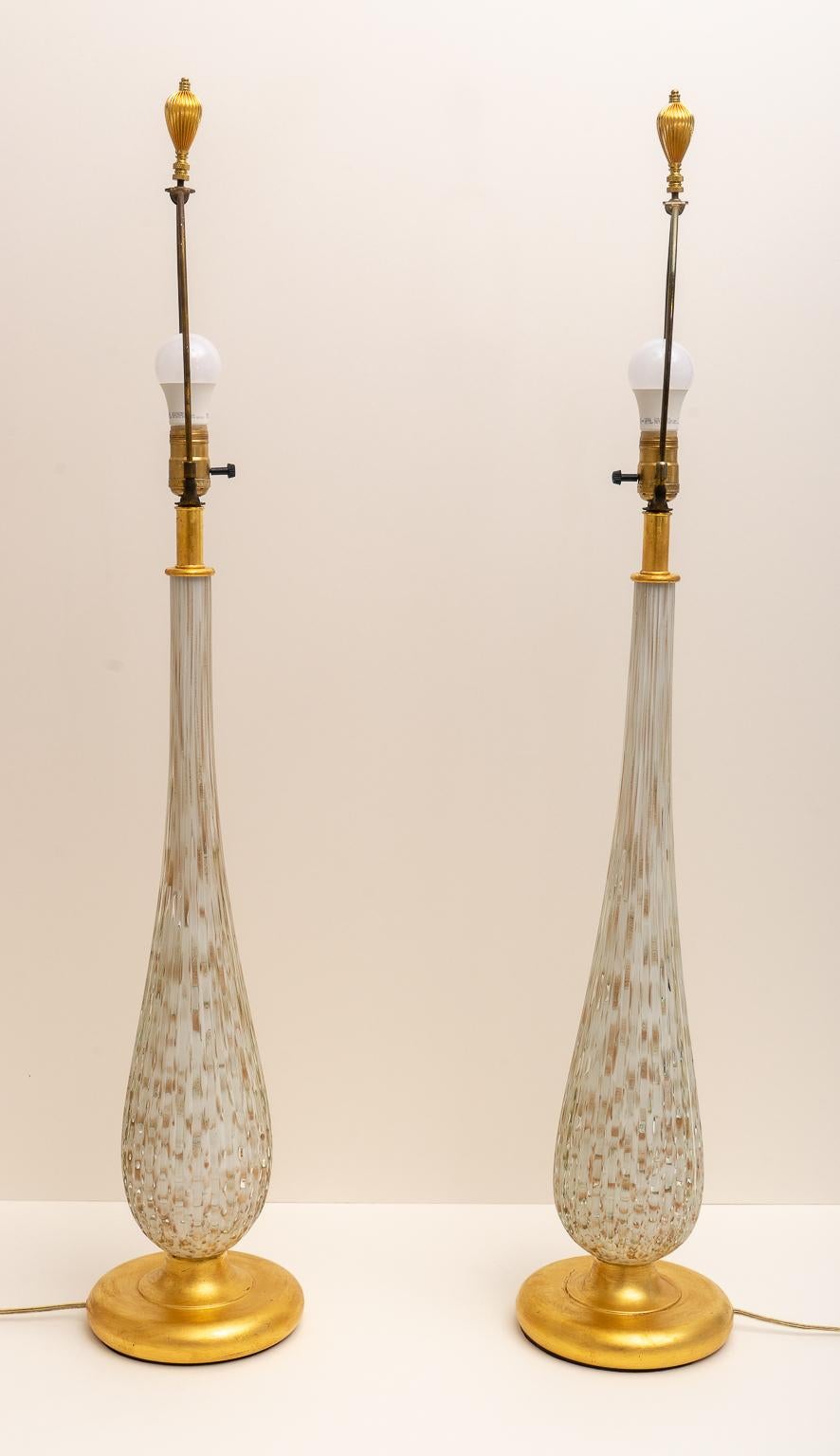 This stylish set of Murano glass tables lamps were acquired from a Palm Beach estate and they will make a definite understated and soft statement with their. 

Note: Height to top of the socket is 31.50