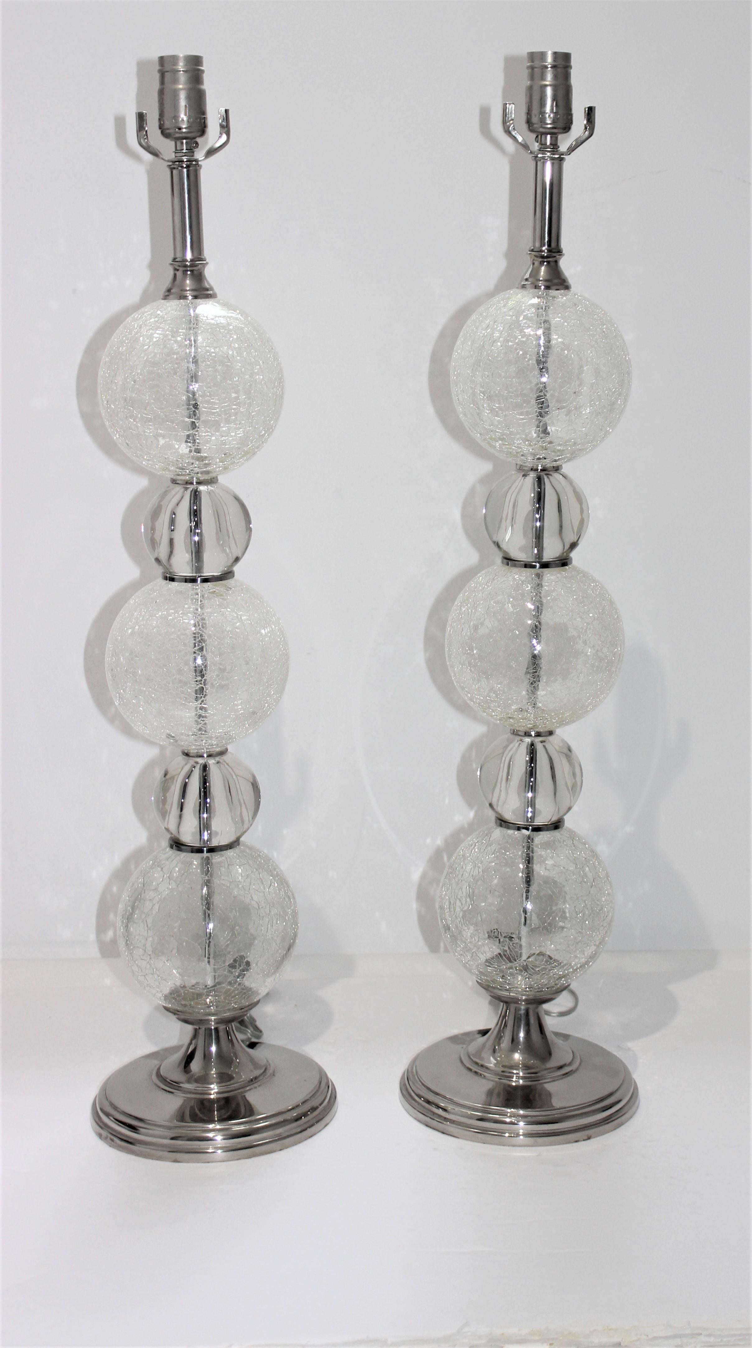 This stylish, large scale pair of table lamps date to the 1980s and are fabricated in polished chrome with clear and crackle pattern Murano glass. The shade are black paper with a white interior.

Note: Dimensions of the lamp shades are 

Note: